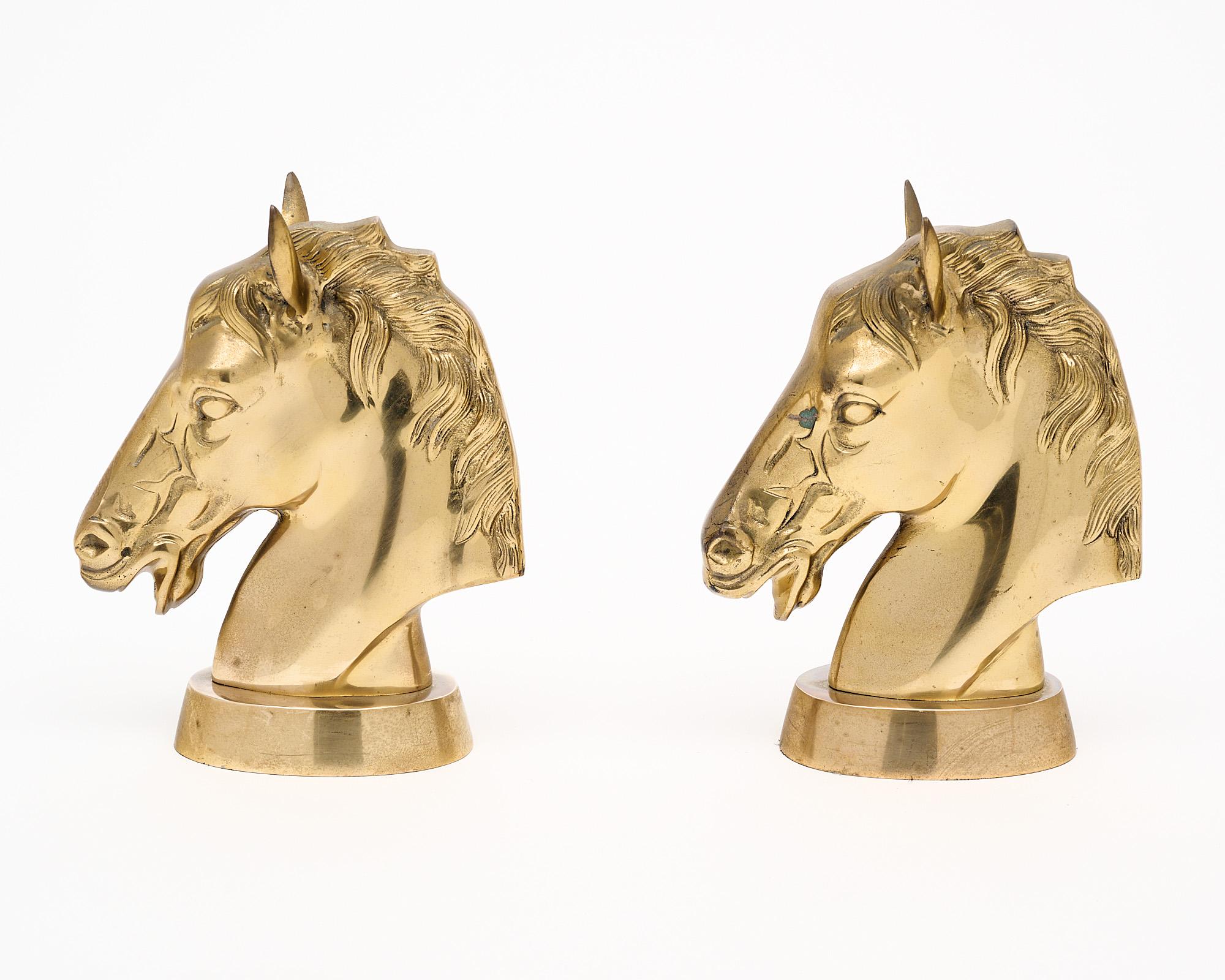 Pair of bookends made of molded brass in the shape of horse heads. This vintage pair is in excellent condition and are in the style of renowned French design house Maison Charles.