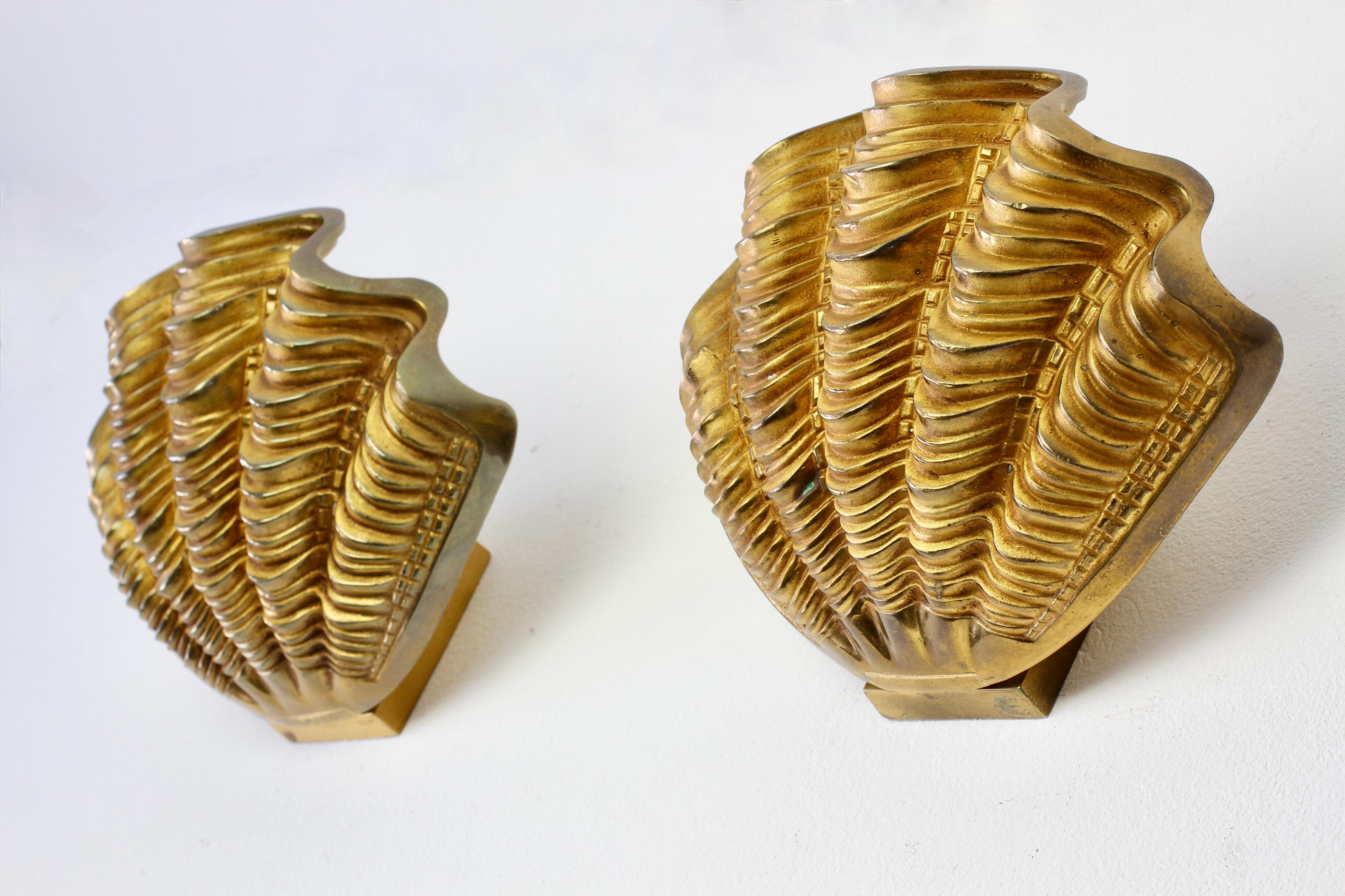Stunning large pair of mid-century wall-mounted sconces in the style of Maison Charles, France, circa 1970s. In the shape of giant fluted clamshells and made of cast bronze, these are not dissimilar to lamps made by Maison Jansen. Perfect for the