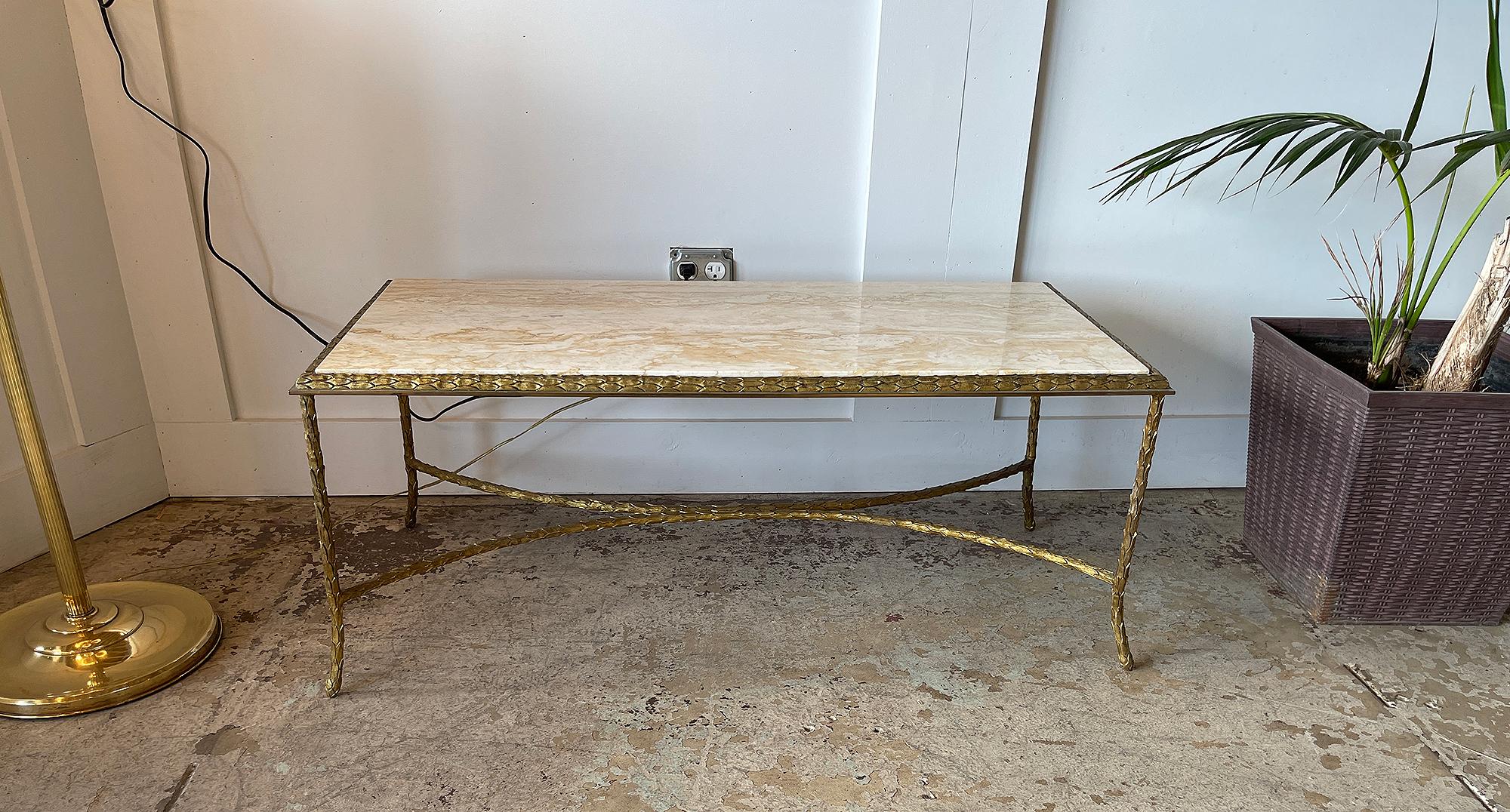 Maison Charles, circa 1960s

This very elegant Maison Charles coffee table is in its original condition; It has a gilt bronze, palm trunk motif frame and a beautiful travertine top. The feet on each leg and the edge have a ram Horn