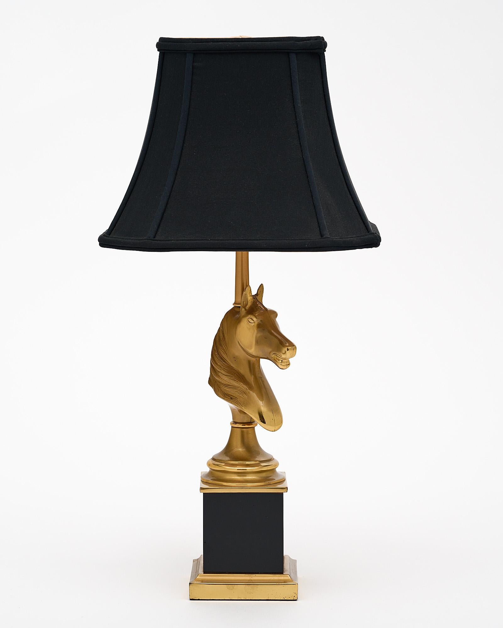A French Maison Charles vintage brass horse-head lamp. This piece is made by the iconic Parisian design power house Maison Charles. We love this strong, unique piece. This lamp has been newly wired to fit US standards.
