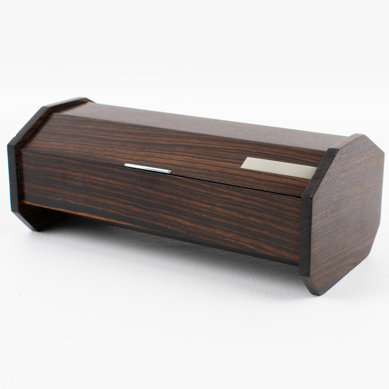 This exquisite French Art Deco decorative box is reminiscent of Desny's work. It features Macassar wood hexagonal sides with chromed metal accents on the lid—French Art Deco decoration at its finest, with excellent quality and a streamlined design.