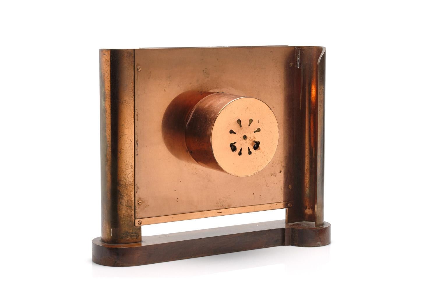 A large and rare Maison Desny clock
France, circa 1930 copper, peach mirrored glass, Macassar ebony,
Signed on back. Measures: 14