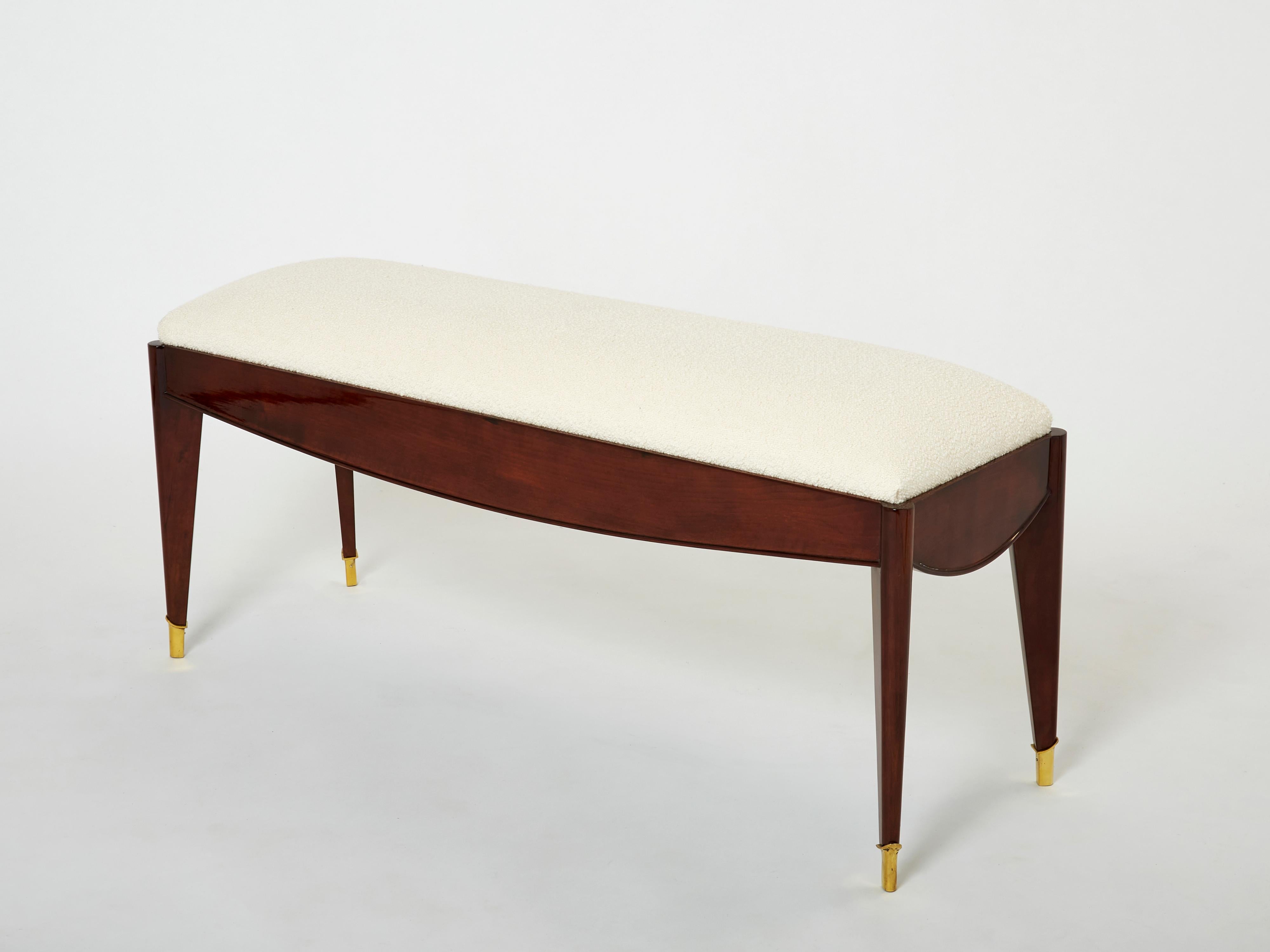 This beautiful French Art Deco bench was made in solid tinted walnut in the early 1940s by Maison Dominique, founded by André Domin and Marcel Genevrière. The design is truly timeless and pure, the brass sabots finishing the piece perfectly. It has