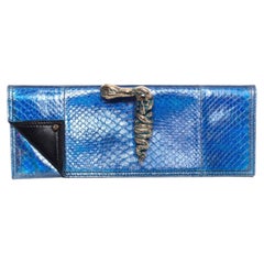 Maison Du Posh, Knuckle ring clutch in metallic-coated snakeskin.
