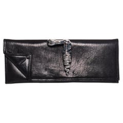 Maison Du Posh, Knuckle ring leather clutch in black.