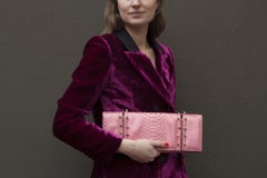 Maison Du Posh, Piercing skull clutch in pink python.
