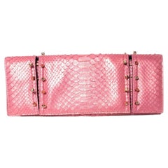 Maison Du Posh, Piercing skull clutch in pink python.