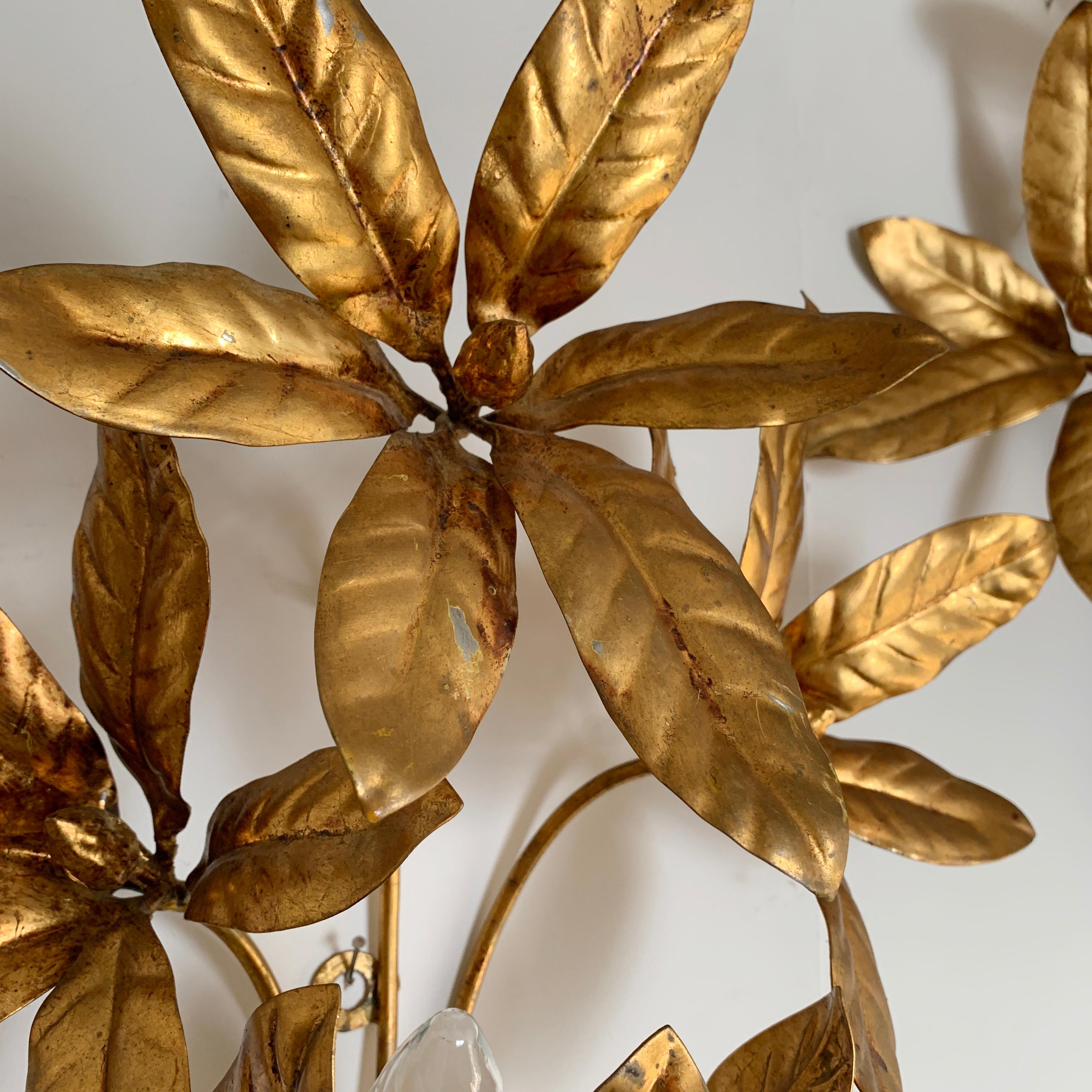 Fabulous gilt flower wall lights by 'Maison Flor Art', France, 1970s
3 large gilt flowers with single bulb holder hidden behind the 3 leaves at the bottom
The lights are in good vintage condition, some losses to gilt in places
Measures: 50cm