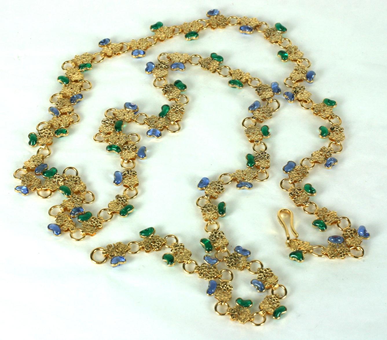 Completely handmade Maison Gripoix for Chanel long elaborate Byzantine link chain of gold plated bronze flexible chain accented with dozens of emerald and pale sapphire Gripoix poured glass enamel petal form motifs. 
Unsigned. Hook closure marked