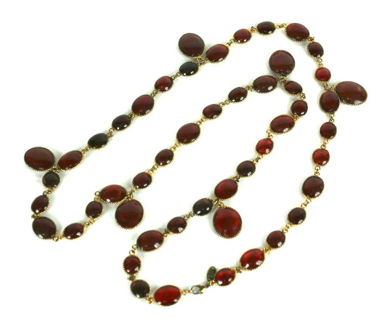 Maison Gripoix for Chanel pastille drop long necklace of deep ruby oval hand made stations in signature poured glass enamel. Sautoir is handmade and designed to be layered and wrapped around neck.
Excellent Condition , Signed Chanel, Antique gold