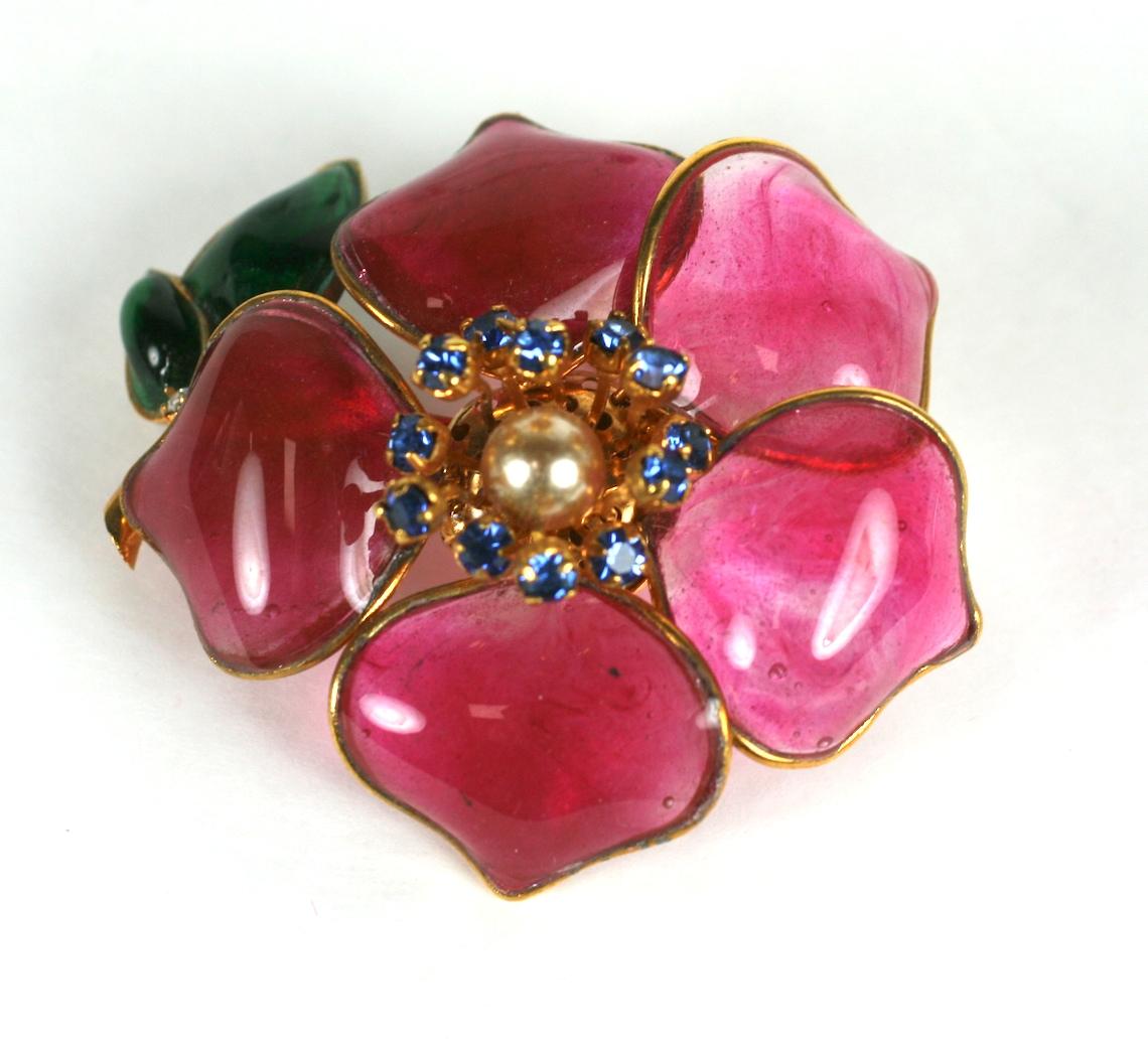 Early Maison Gripoix for CoCo Chanel 1950s camellia brooch. Of pale ruby and deep emerald Gripoix poured glass enamel in a gilt plated bronze handmade setting. Further accented with a hand set sapphire crystal stamen and center ivory nacre pearl.