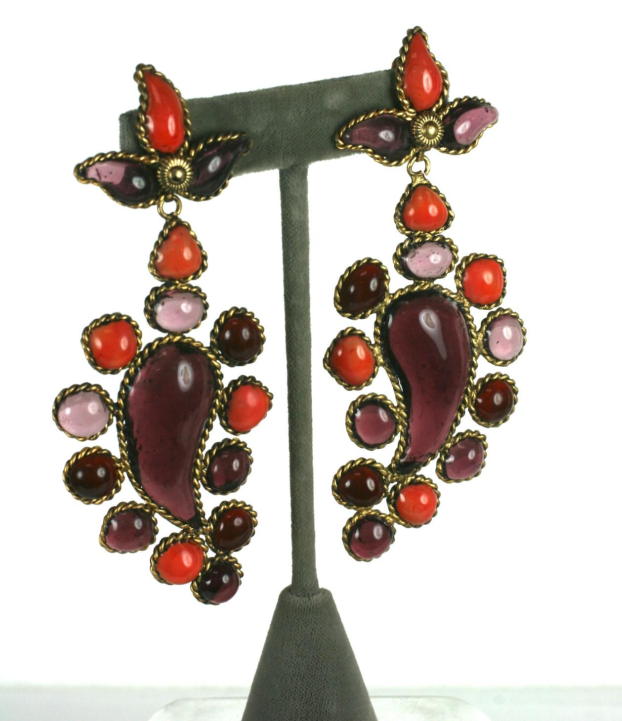 Maison Gripoix for Yves Saint Laurent Anglo Indian palmette long earrings made of coral and two shades of amythest poured glass enamel. Set in spun gilt bronze wire. Spring/Summer 1982 Haute Couture Collection. Clip back fittings.
The earrings are