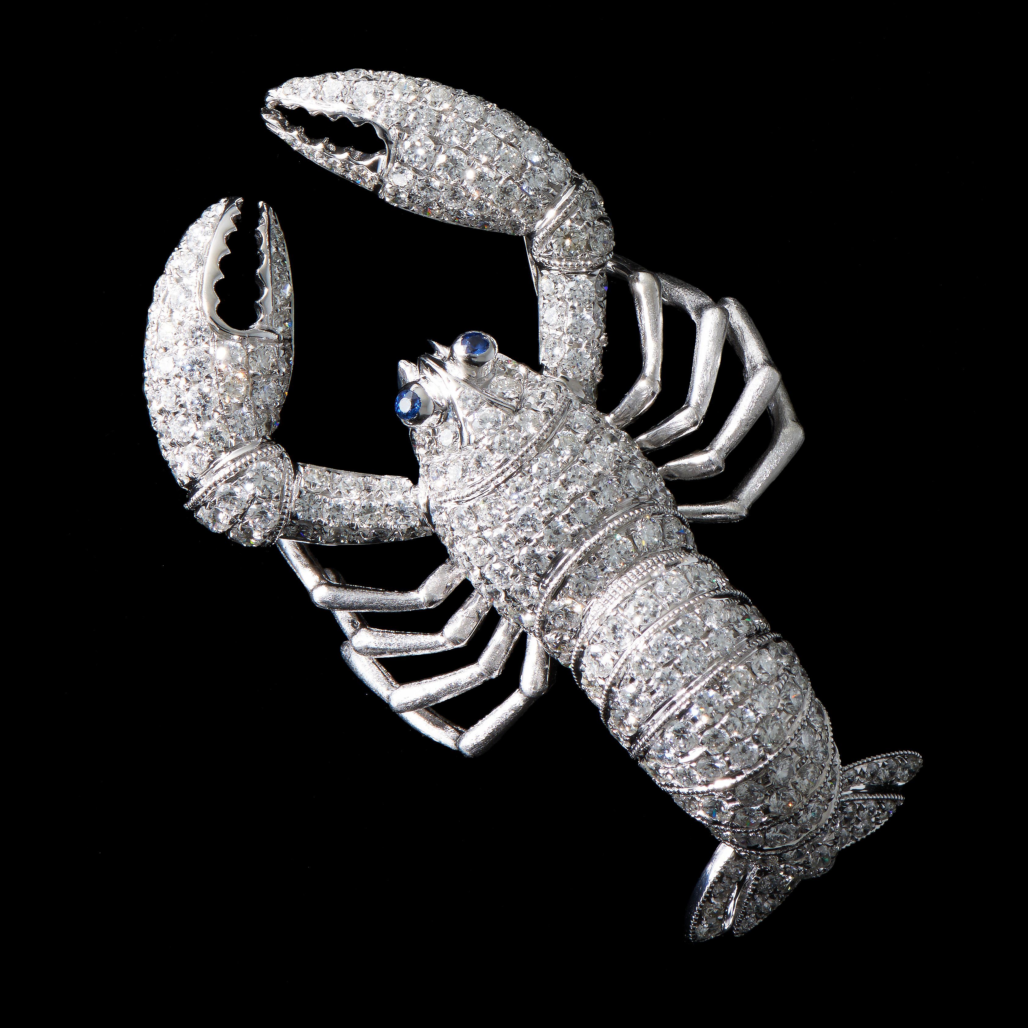 Lobster 

2 Sapphires (0.05ct), 226 Diamonds (4.371cts), 18K White Gold.
Length: 52mm

Body of the lobster is articulated into several segments that can be moved slightly. A playful and interesting piece of jewellery.