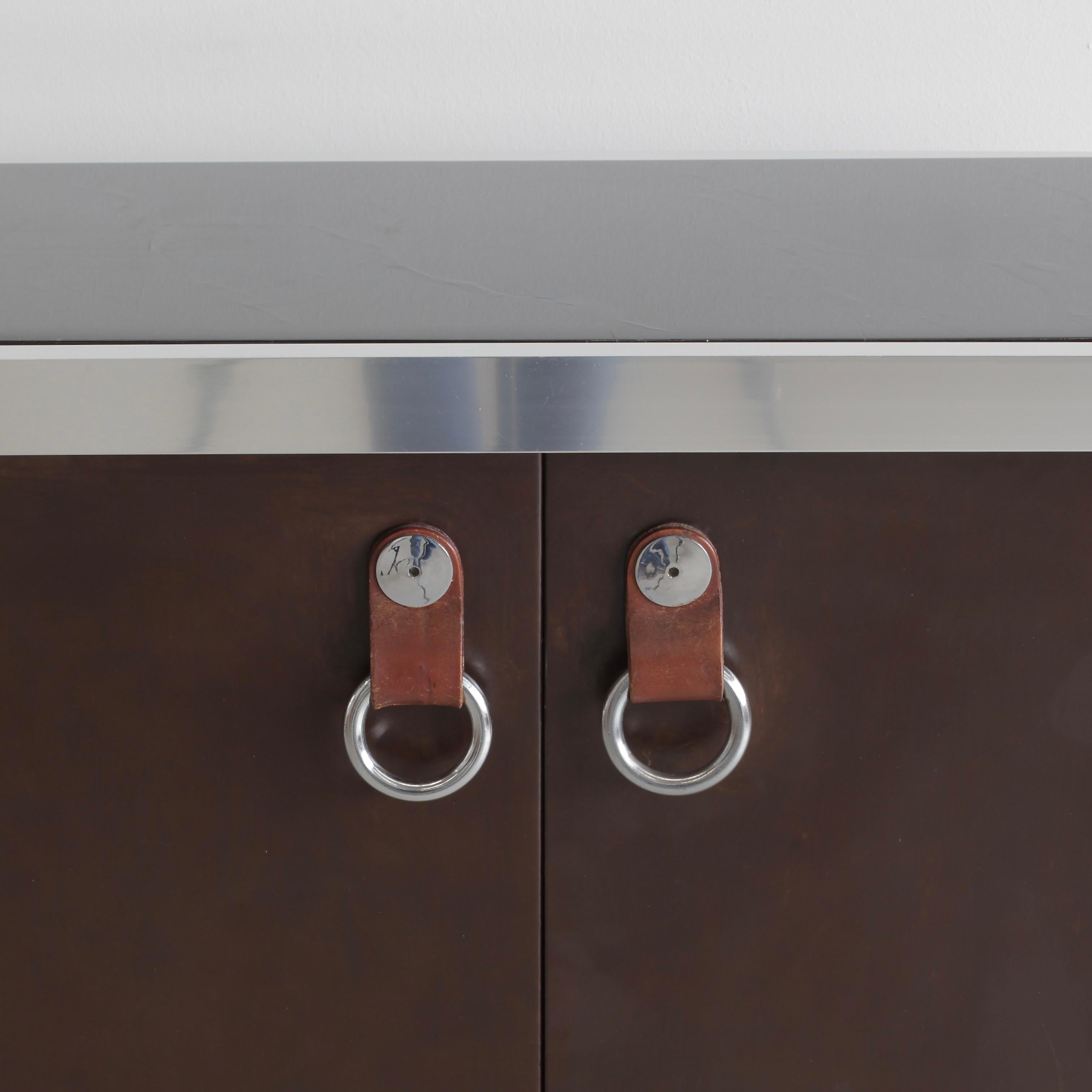 A cabinet designed by Faleschini for Maison HERMES and produced by MARIANI in the 1970s. Four removable shelves, covered in brown felt on the inside and on the outside. Marble top, doors mounted on long metal hinges, the doors have the HERMES style