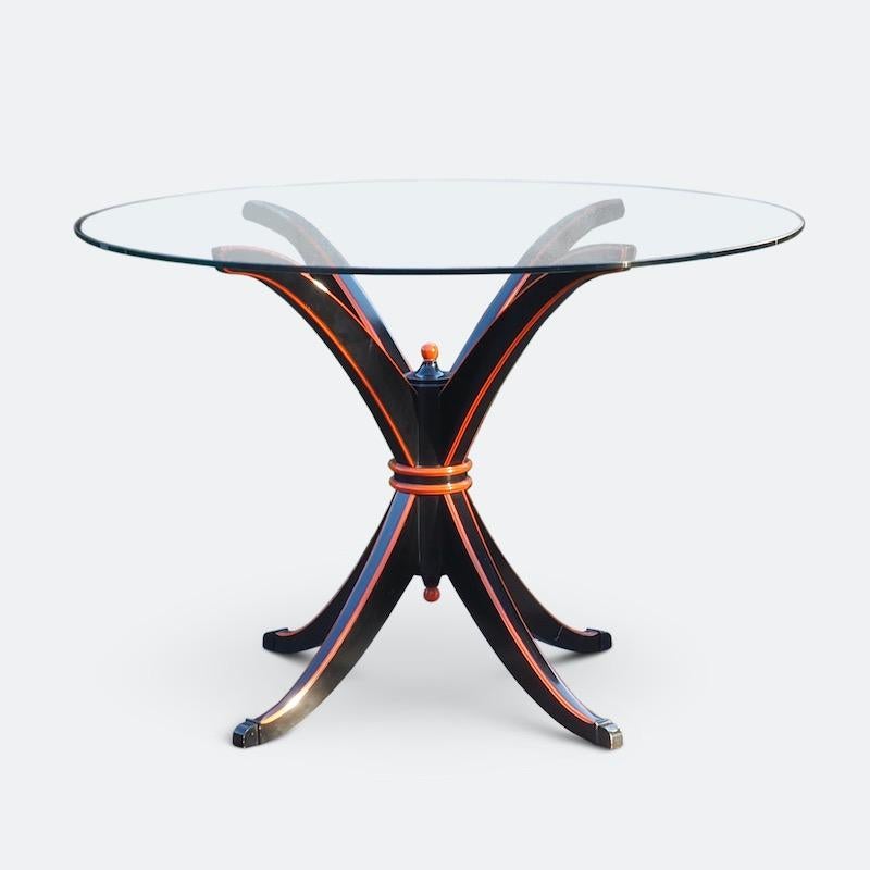 A superb Maison Hirsch dining table in black lacquer with orange lacquer edging and finials on black lacquered bronze feet. Inspired by the grand neoclassical period of the mid-18th century Maison Hirsch were at the cutting edge of the 