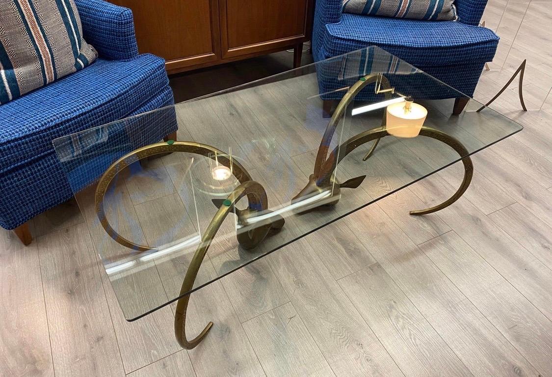 Stunning brass and glass rams head cocktail table with great scale and better lines.
All original with age appropriate wear. Styled after Chervet circa late 1960s.
All dimensions are below. Now, more than ever, home is where the heart is.
