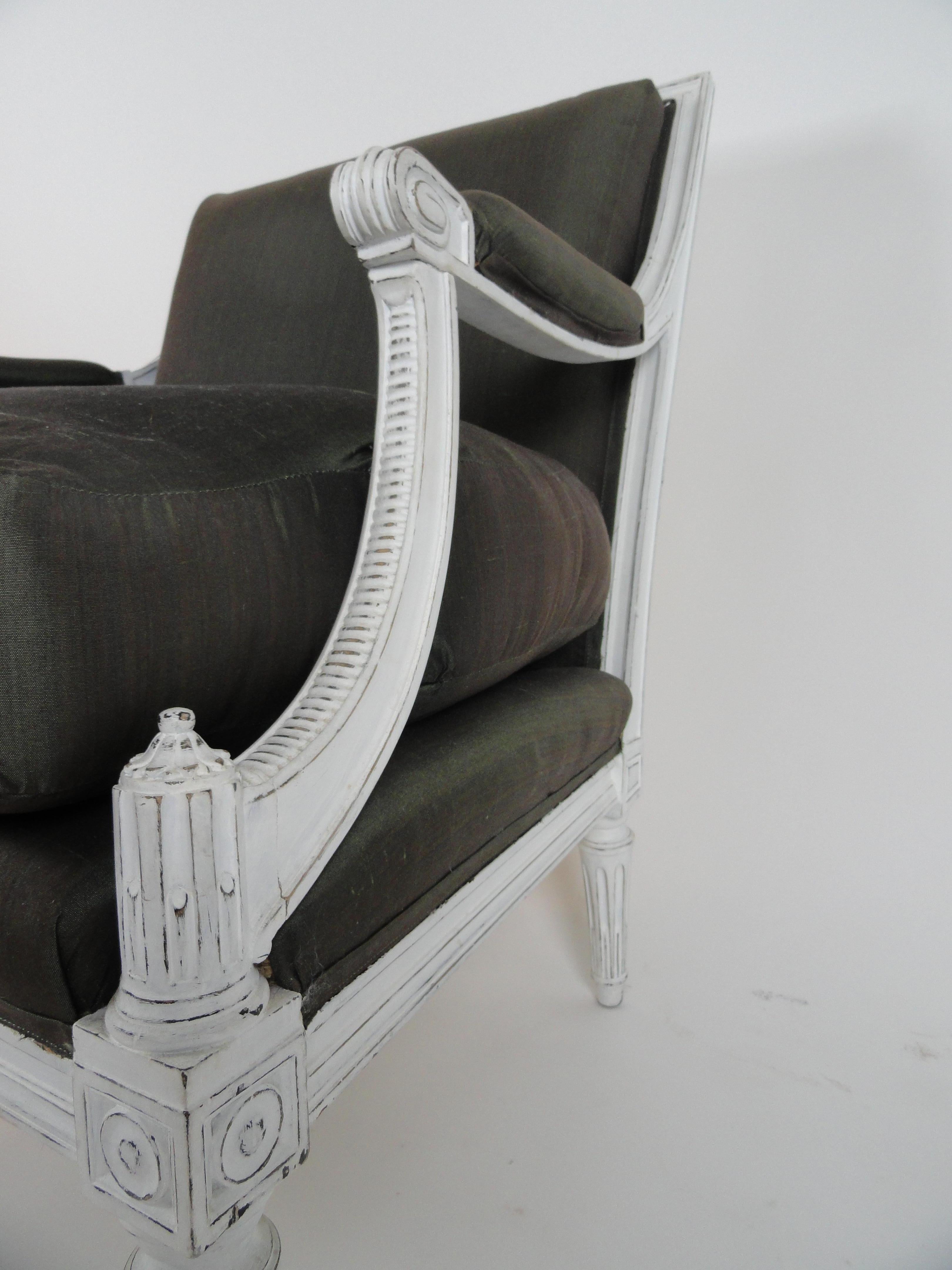 Maison Jansen Louis XVI style armchair or fauteuil. Wood painted white, newer finish, and distressed. Upholstered in Henry Calvin Athena Taffeta (50% silk, 50% cotton). Comfortable.
