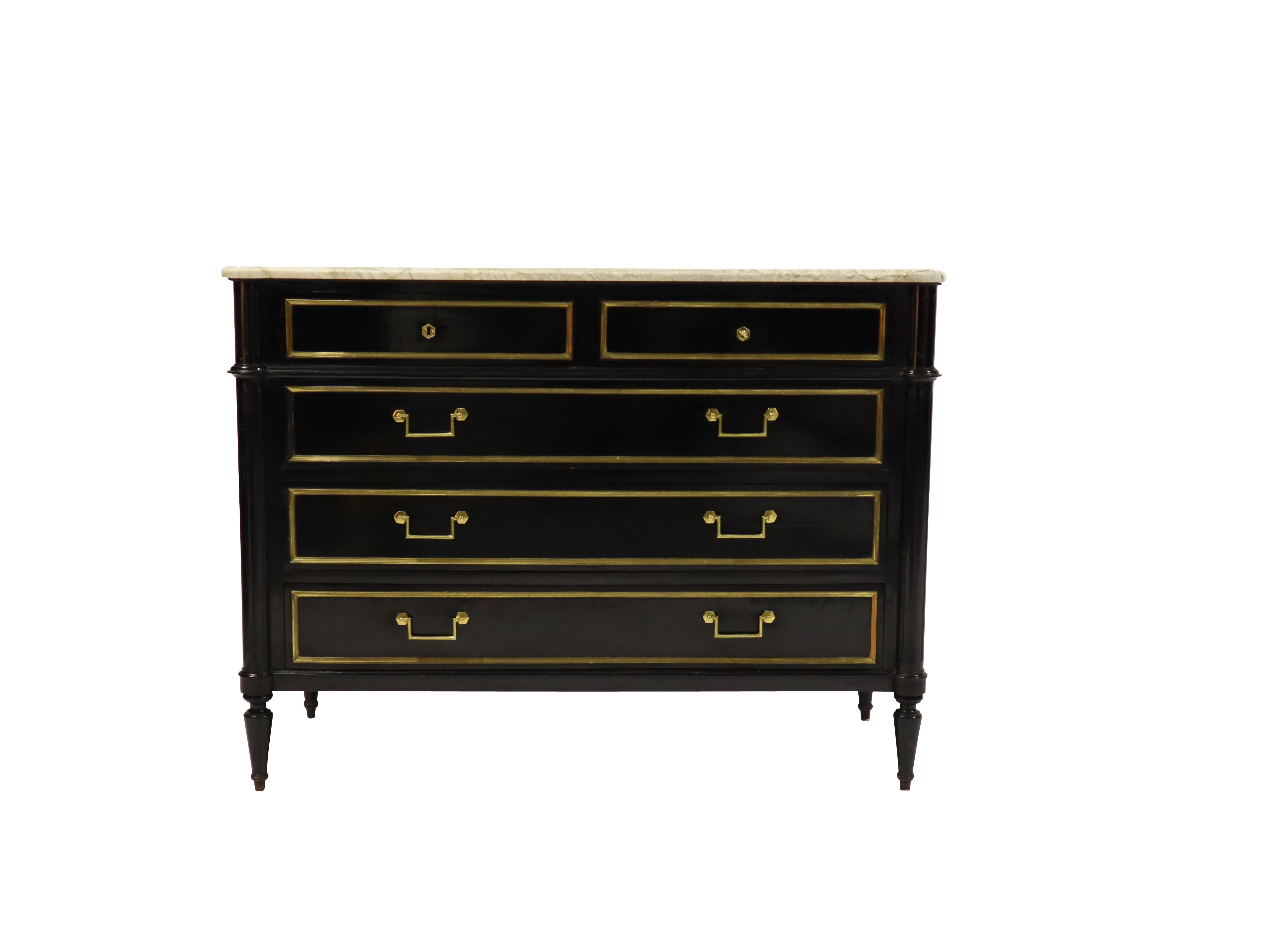 French chest attributed to Maison Jansen. Ebonized wood with brass trim details and marble top.