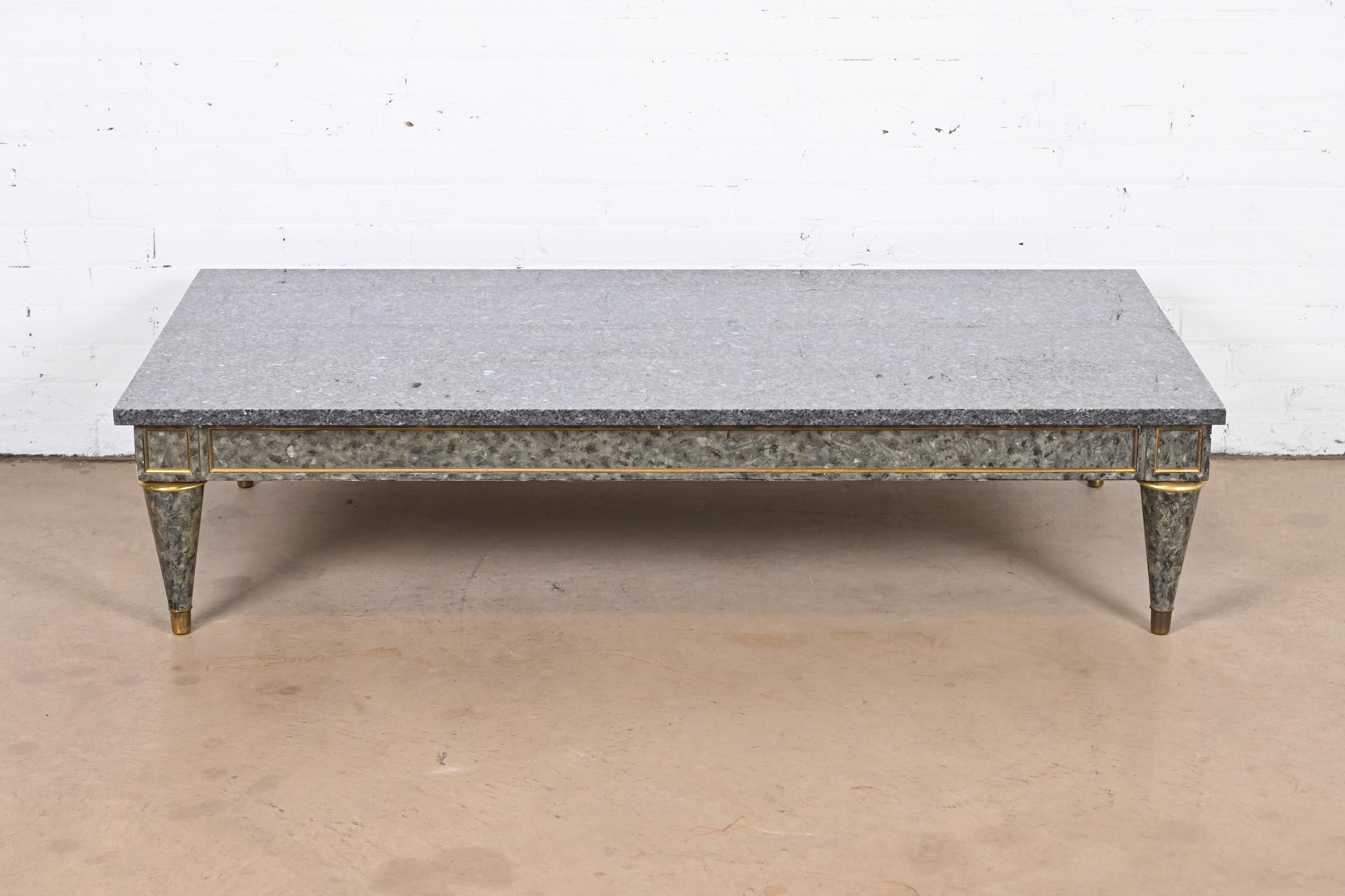 A gorgeous French Regency Louis XVI style coffee table

Possibly Maison Jansen

France, Circa 1960s

Beautiful granite top, with faux marble painted wood base with gold gilt details.

Measures: 60