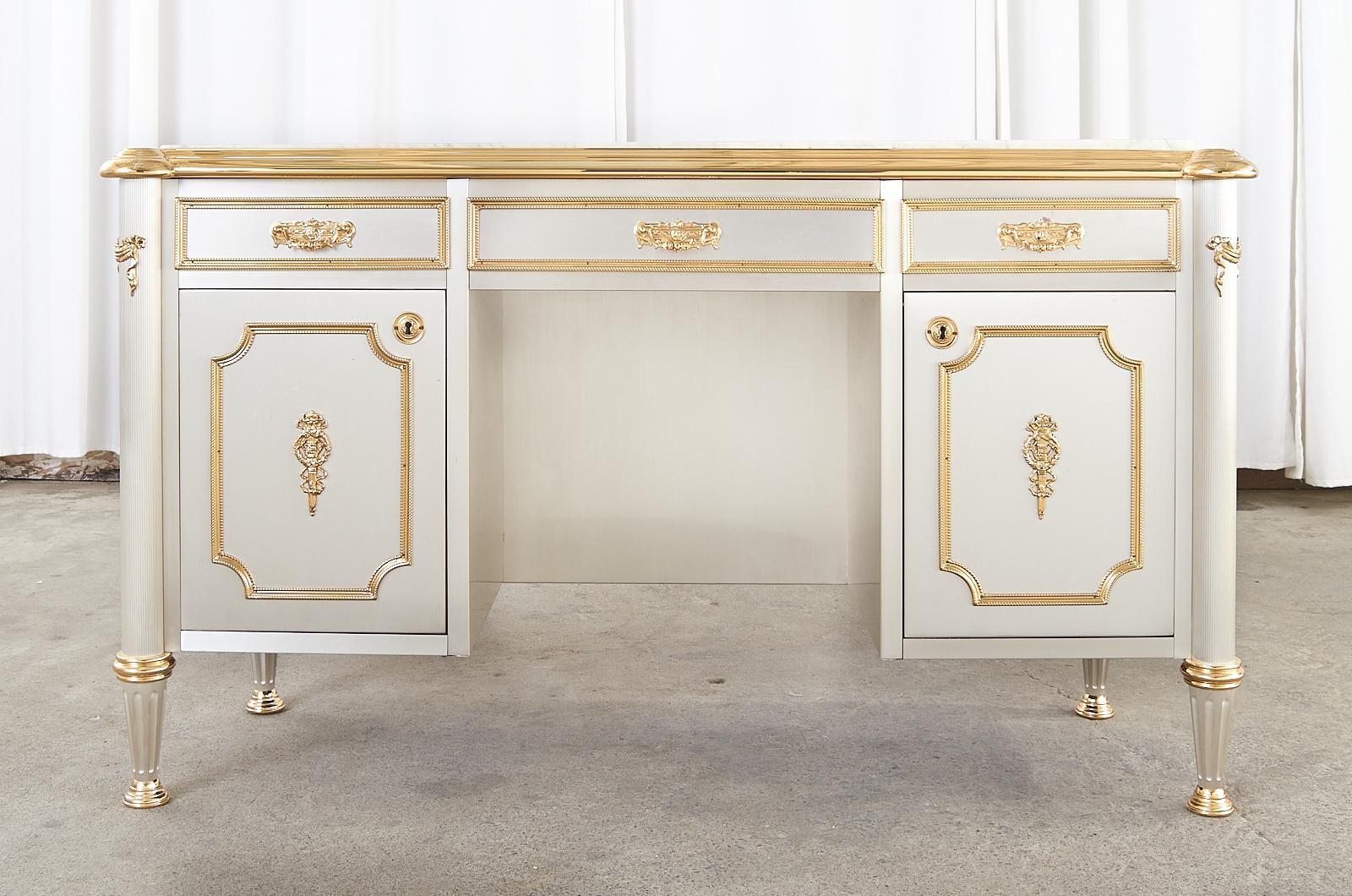 Opulent stainless steel mahogany writing table, bureau plat, or desk attributed to Maison Jansen, France. The desk features a thick slab of quartz Carrara style marble on top with thick polished brass trim. The case is crafted from rich radiant