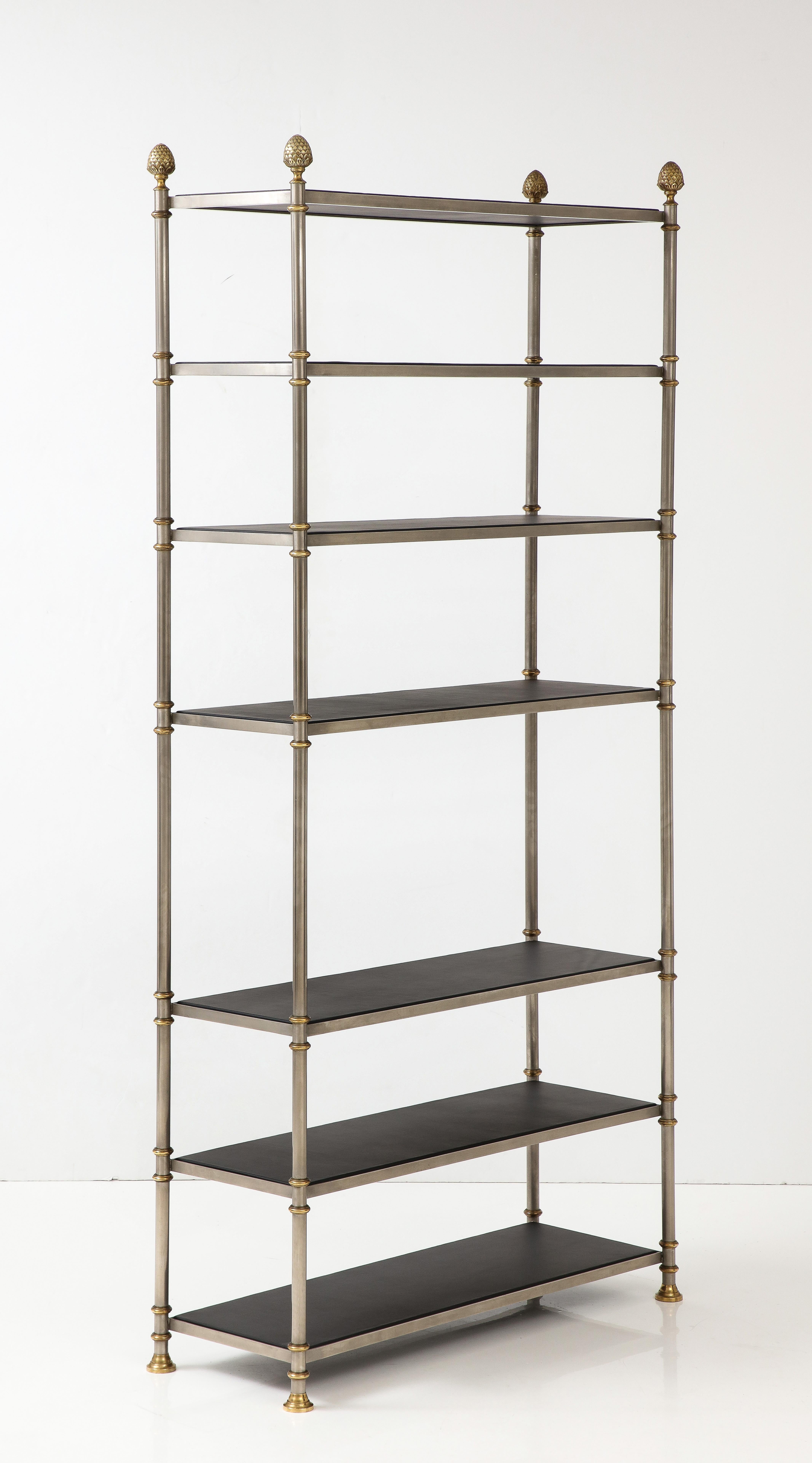 1970's steel and brass with leather shelves Etagere Attributed  Maison Jansen stamp made in Italy, in vintage condition with minor wear and patina due to age and use.