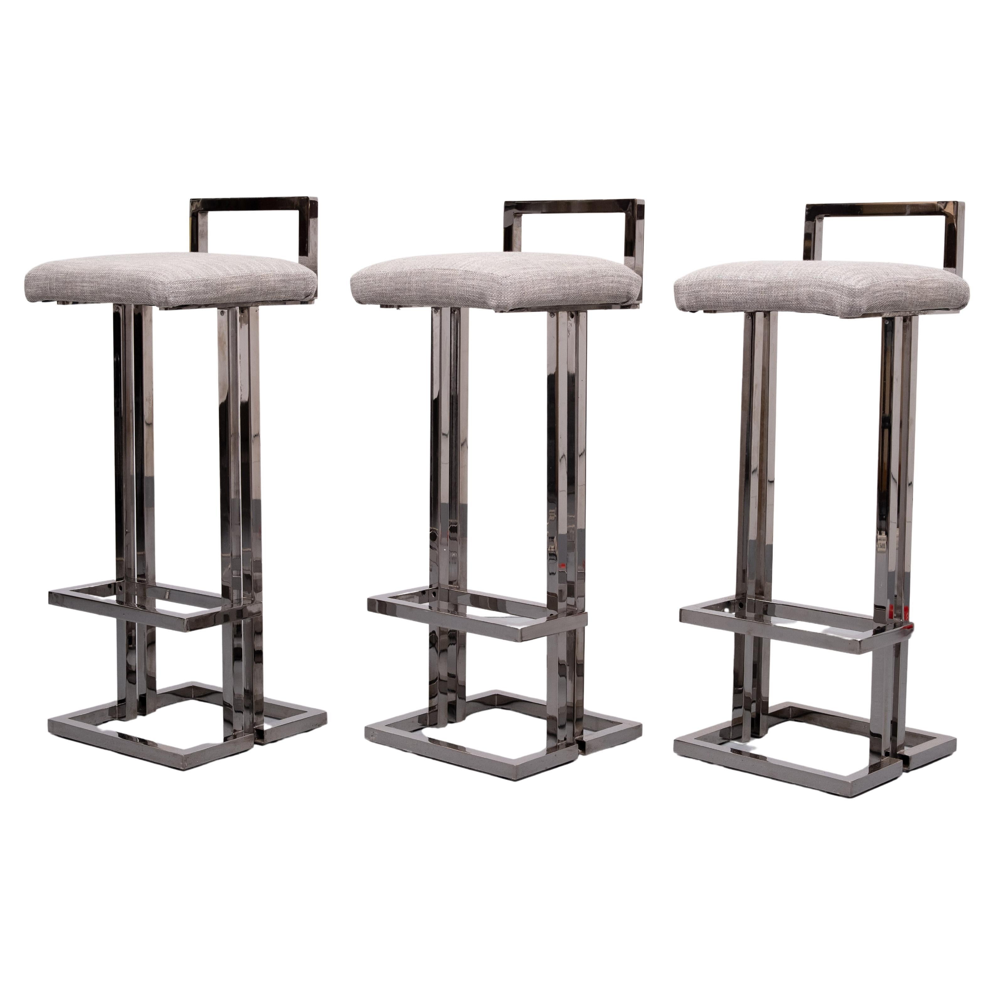 Set of Three Belgo Chrom Bar stools , In a smoked Chrome color .
comes with new Grey fabric upholstery . so stylish. 
in a good condition ,with the normal wear and tear after 50 years of use  .