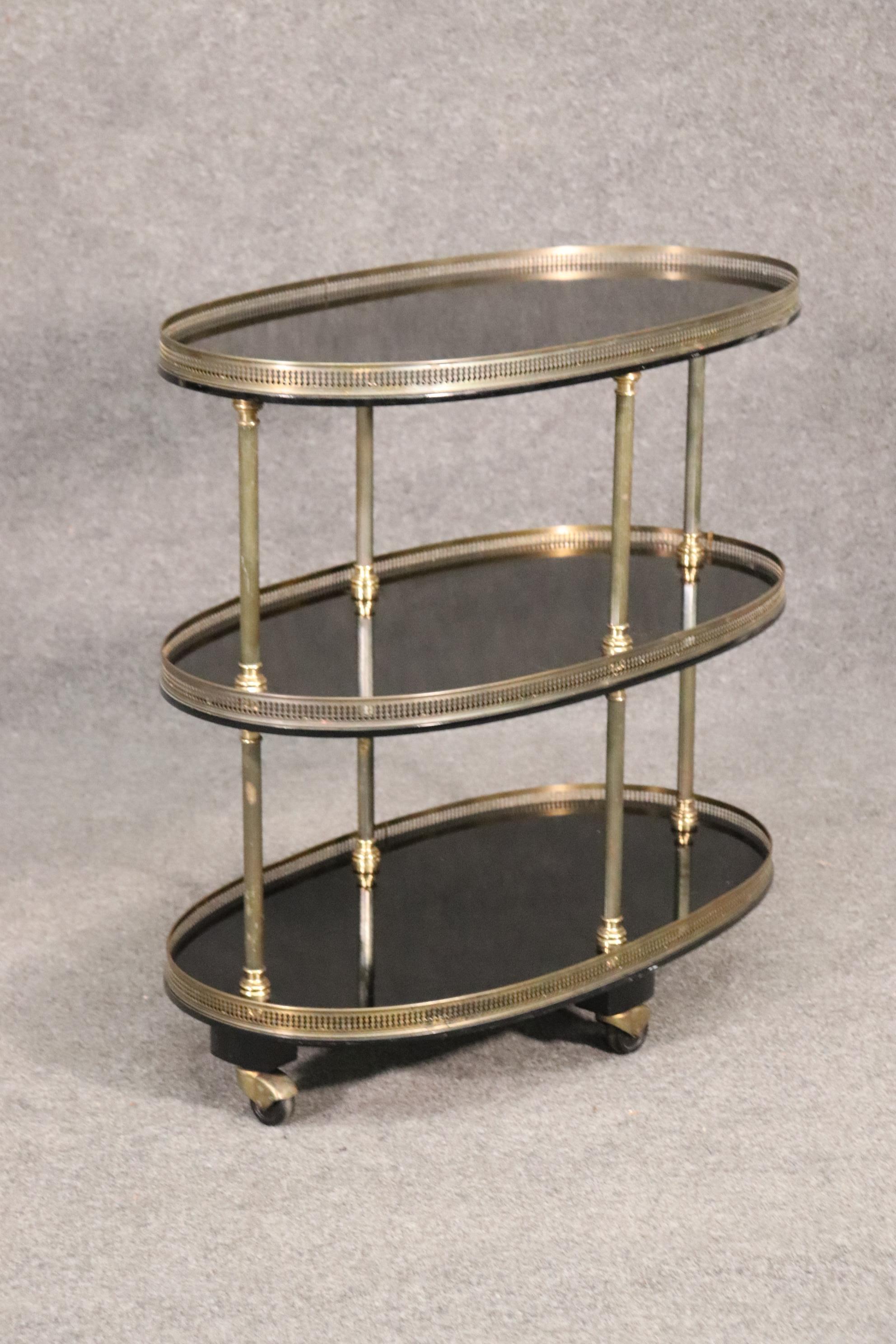 This is a gorgeous oval signed Maison Jansen dessert or tea cart. It could be also used for serving liquor or drinks. The cart is in very good vintage condition. The cart measures 31 tall x 32 wide x 18 deep. This is from the 1960s.