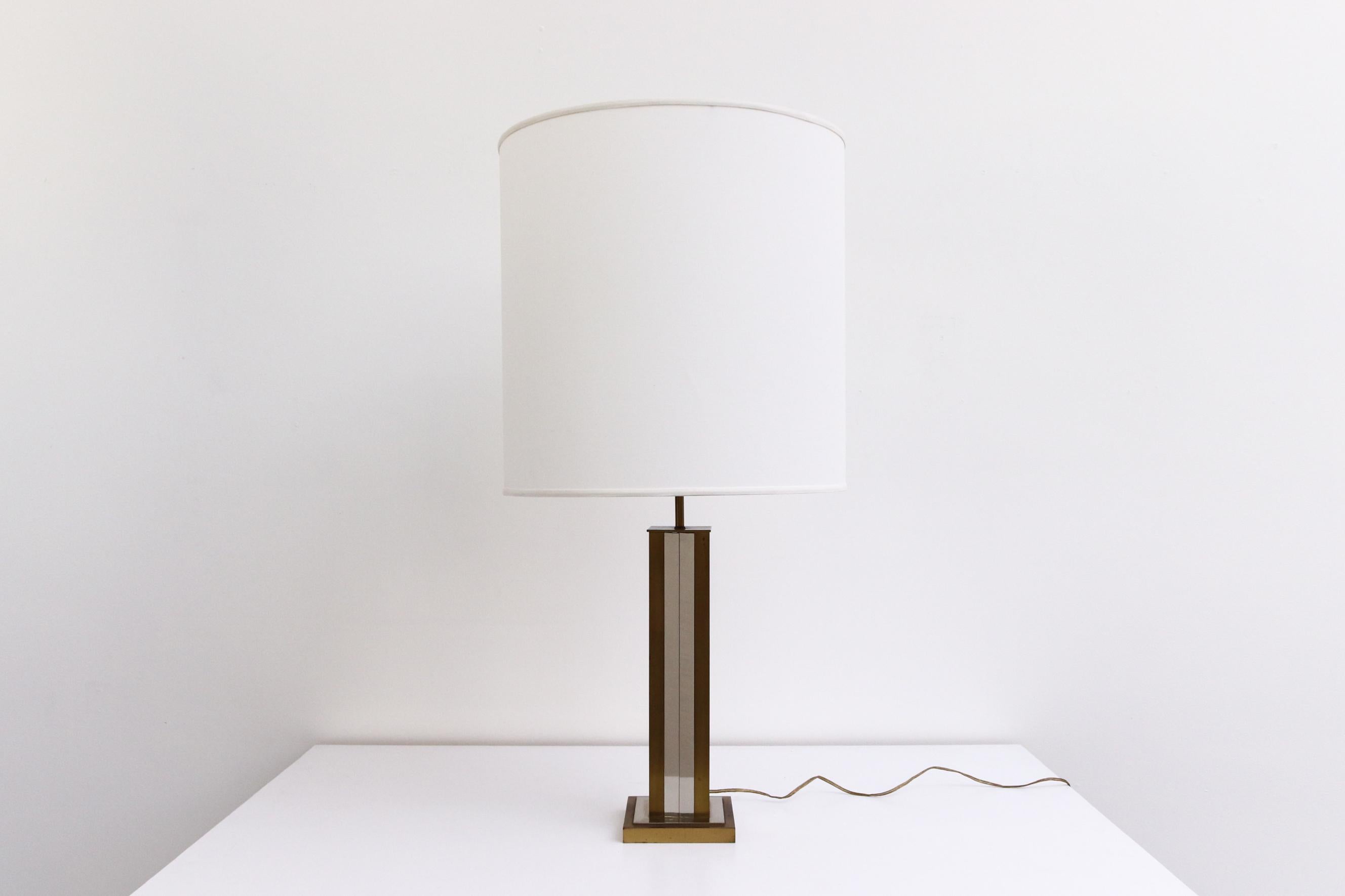 Maison Jansen brass, chrome, and steel table lamp by Leo Koek. In original condition with visible patina and some tarnishing. Wear is consistent with age. Shown with a new linen lamp shade.