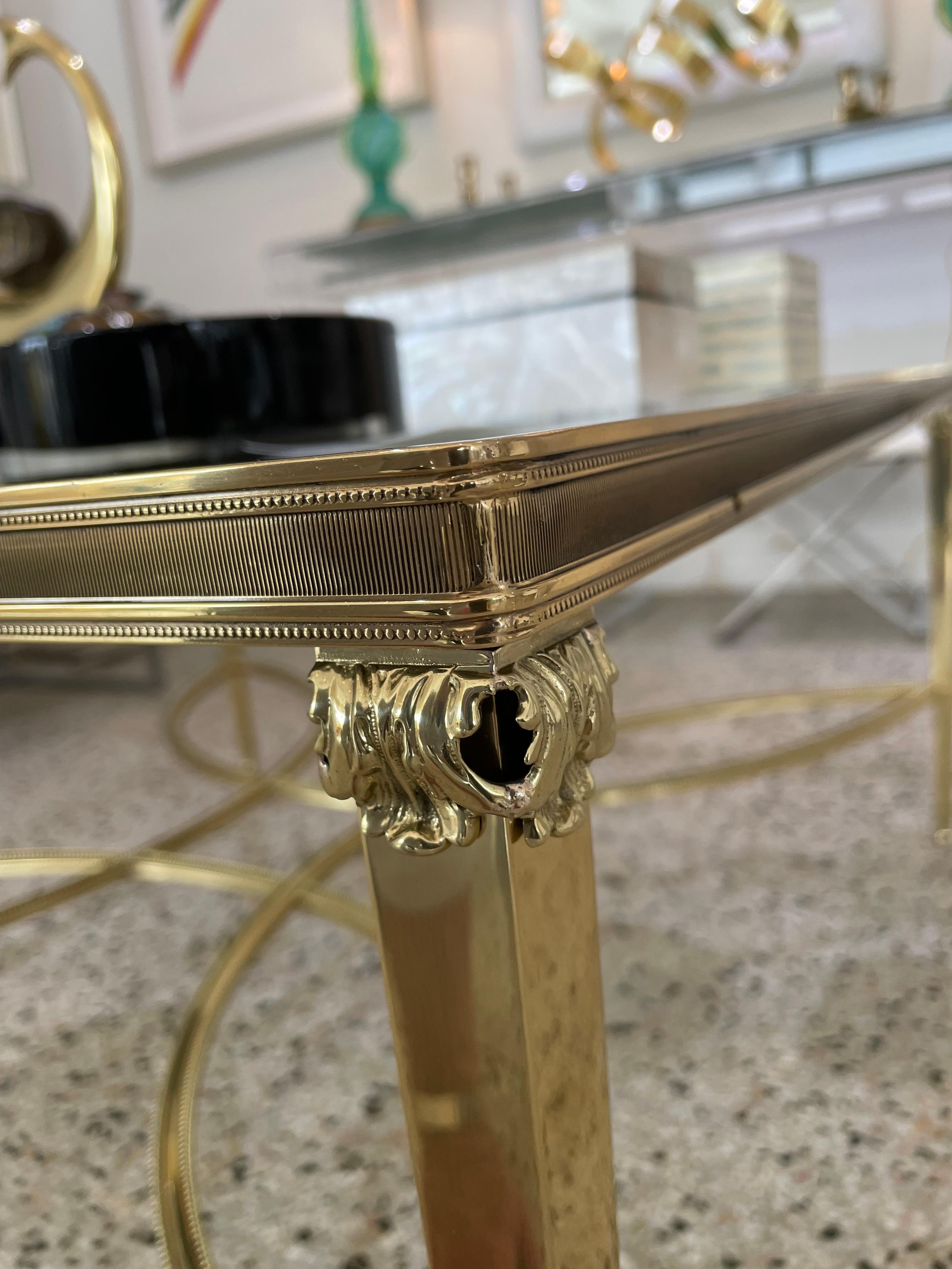 This stylish, chic and large scale cocktail table was created by the iconic French firm of Maison Jansen, and it dates to the 1960s-1970s.

Note: The brass has been professionally polished and lacquered, so no tarnishing.

Note: The glass has a