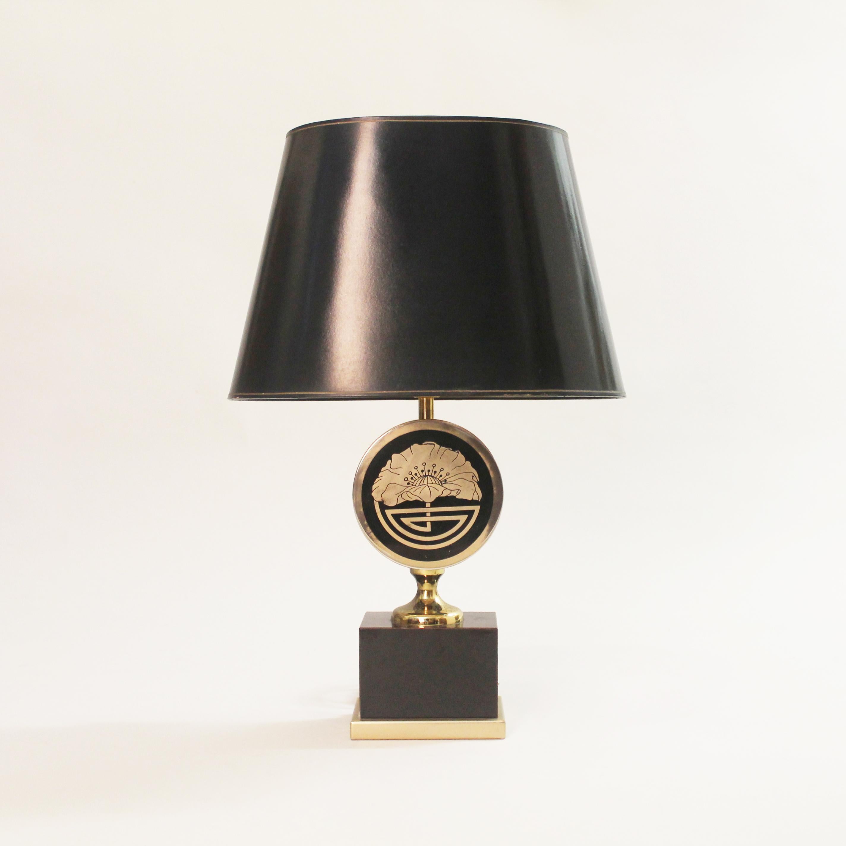 Unique table lamp on a black base, topped with a round elaborate flower and geometric design in the Art Deco style. Black gold oval shade is included. 

Please contact us for international quotes.

CREATOR: Maison Jansen

PLACE OF ORIGIN: