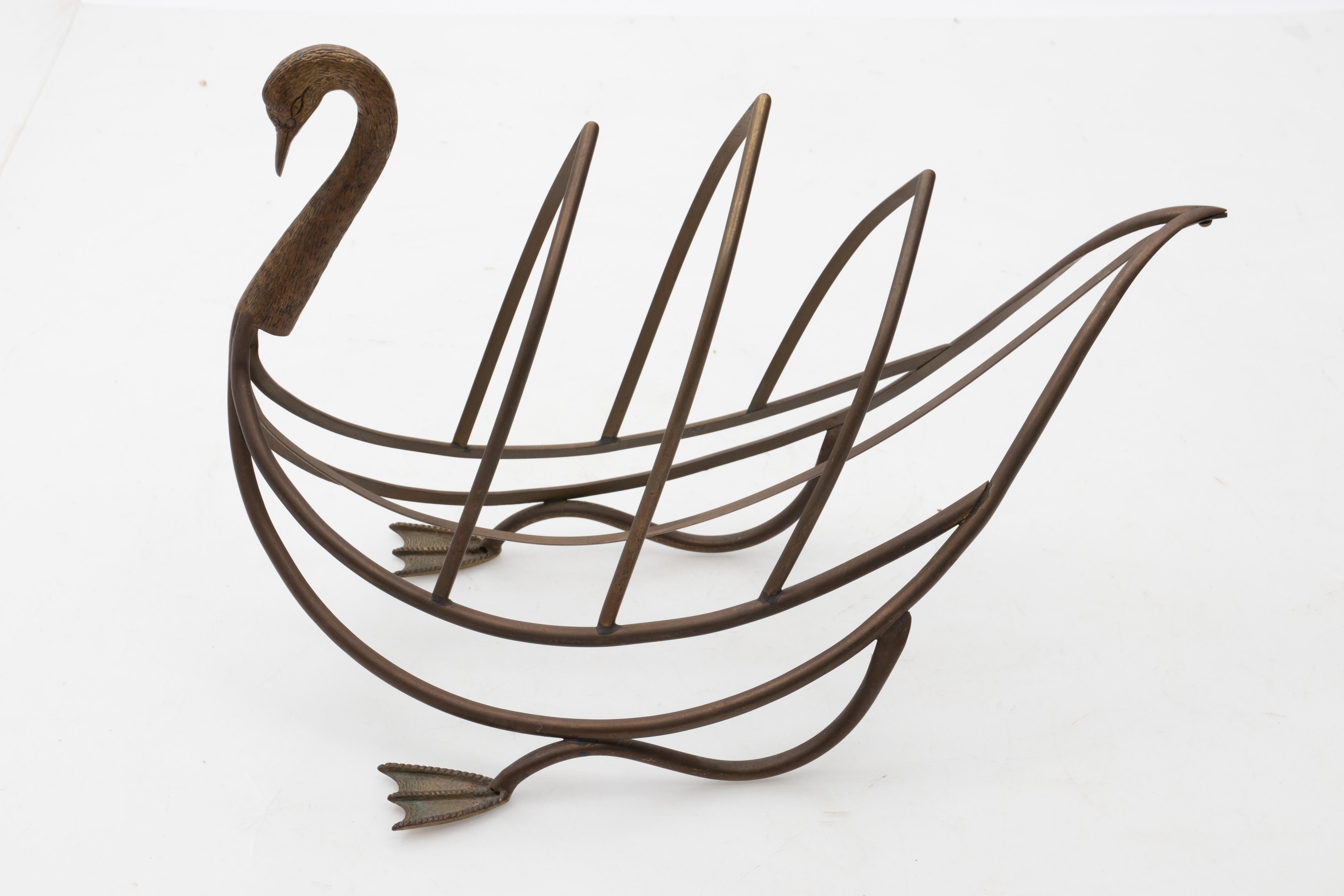 Brass magazine rack in the shape of a swan with original patina, circa 1960s, Attributed to Maison Jansen. Please note of wear consistent with age including oxidation. Made in France.