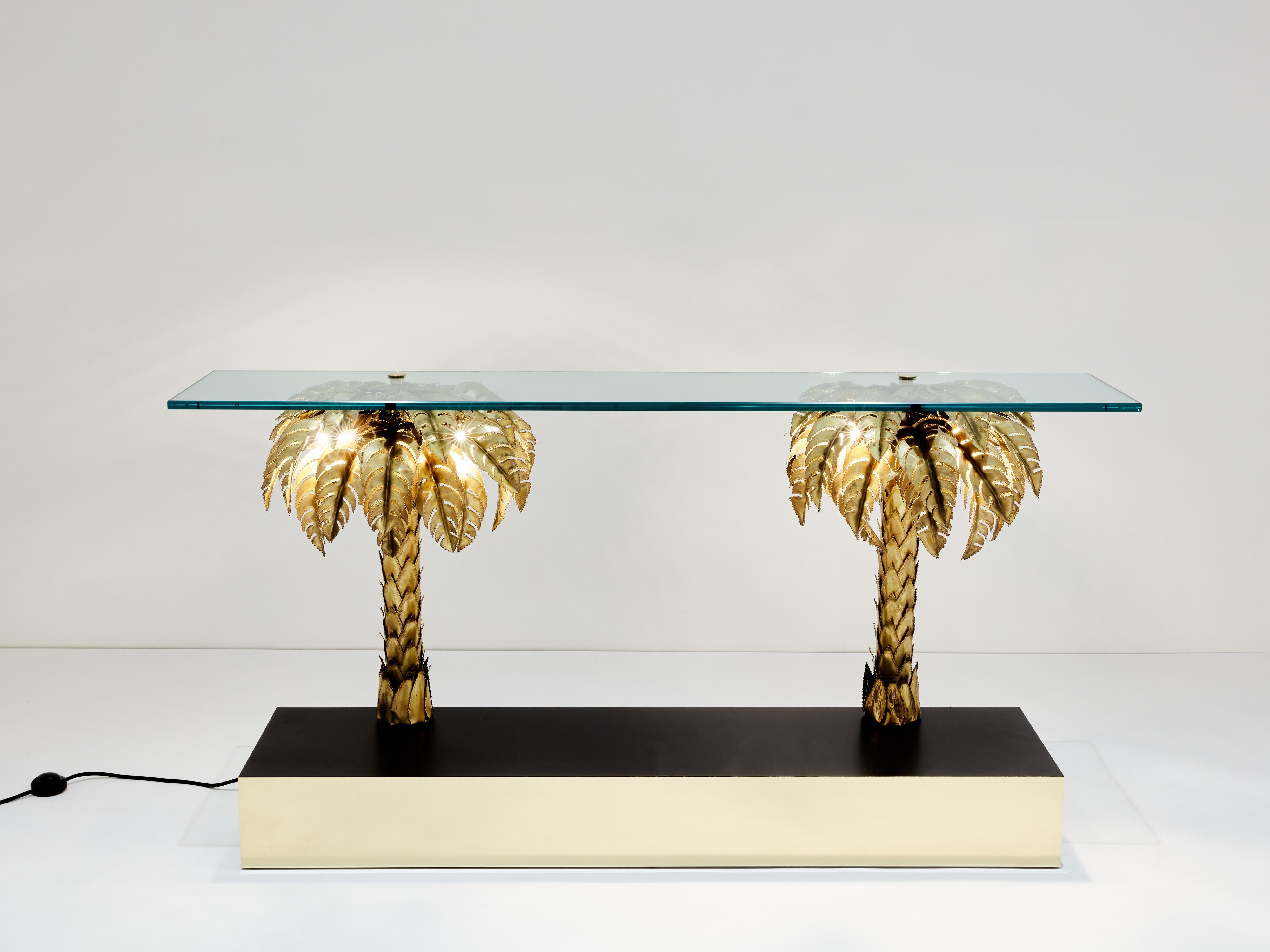 These palm tree sculptures are probably the most iconic pieces by French design firm Maison Jansen in the 1970s. This very rare example is made of two large palm trees sitting on a black wood and polished brass base, and topped with a transparent