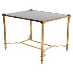 Mesa auxiliar de latón Maison Jansen con tapa dorada y ebonizada