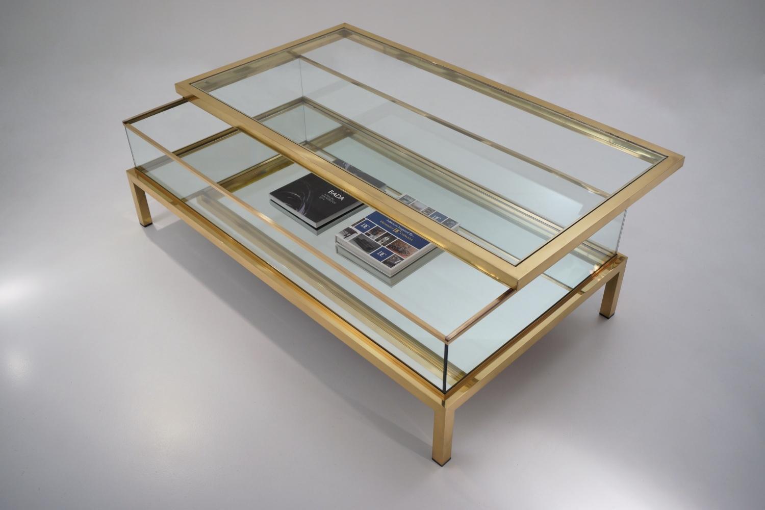 Maison Jansen brass two tier sliding top display coffee table, with mirrored enclosed shelf, 1970`s ca, French.

This coffee table has been gently cleaned while respecting the vintage patina and is ready to use.

The Neoclassical & Modernist