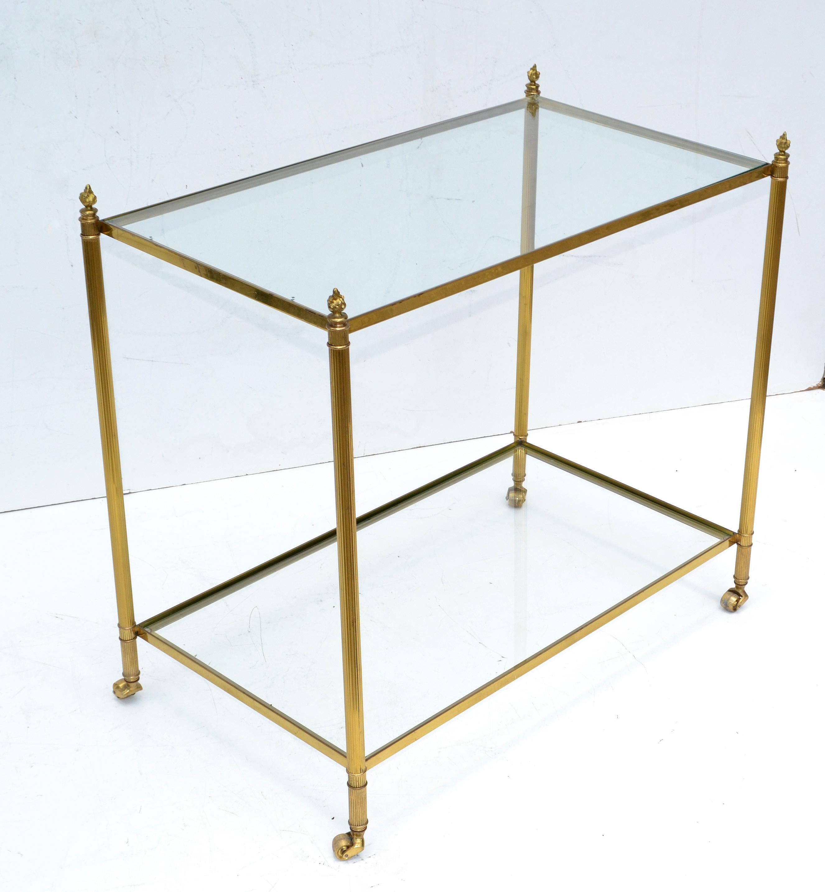 Superb 2-tier side table or serving cart by Maison Jansen neoclassical made in France circa 1960.
Bronze Core on Casters with clear Glass tops.
Great also as sofa, end or tea table.
Space in between measure: 20 inches.