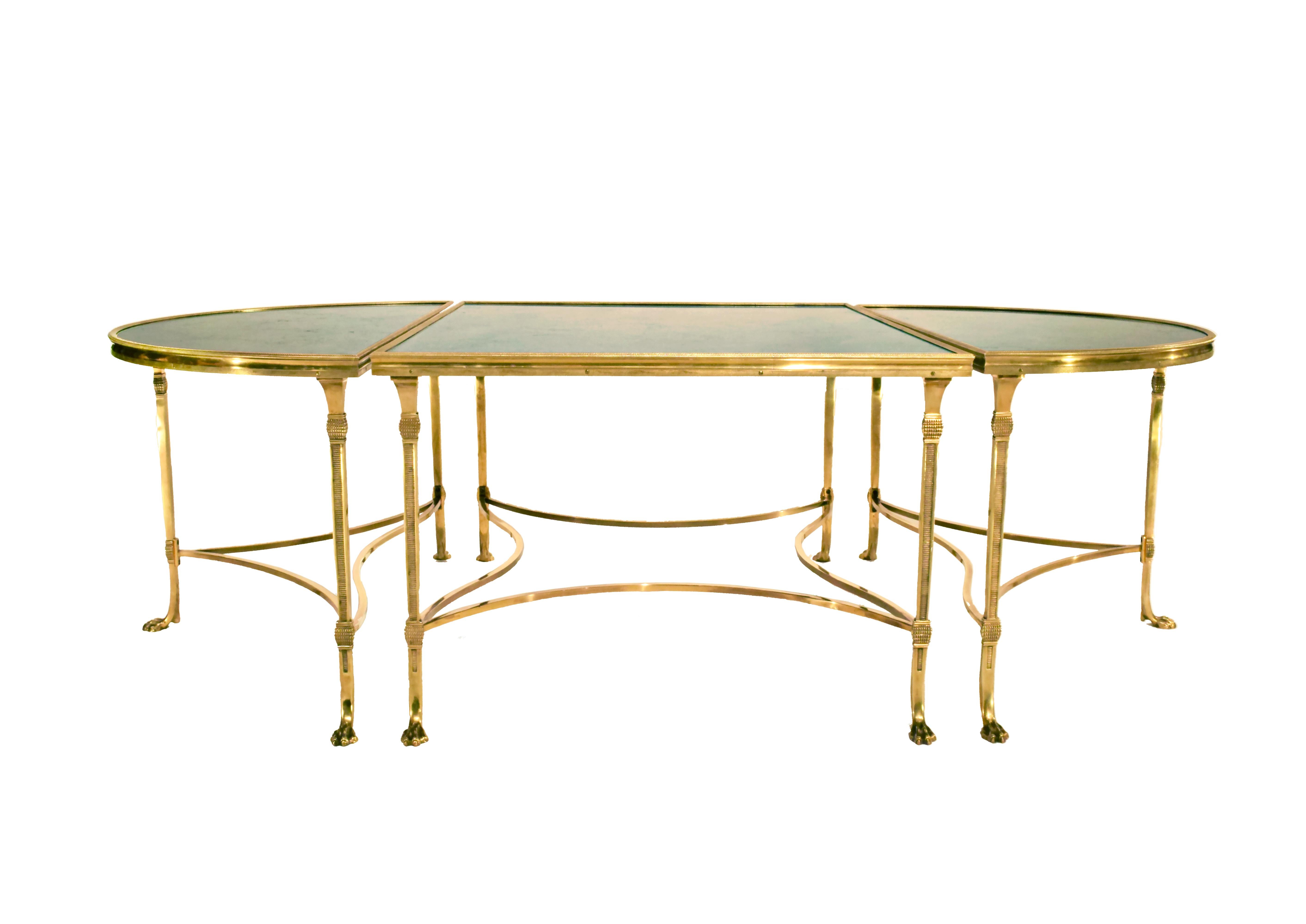 A Maison Jansen design midcentury neoclassical bronze and honed black fossilized marble tripartite cocktail table with a hardwood structural core, manufacture attributed to Maison Bagues, in three parts comprised of a rectangular center section and