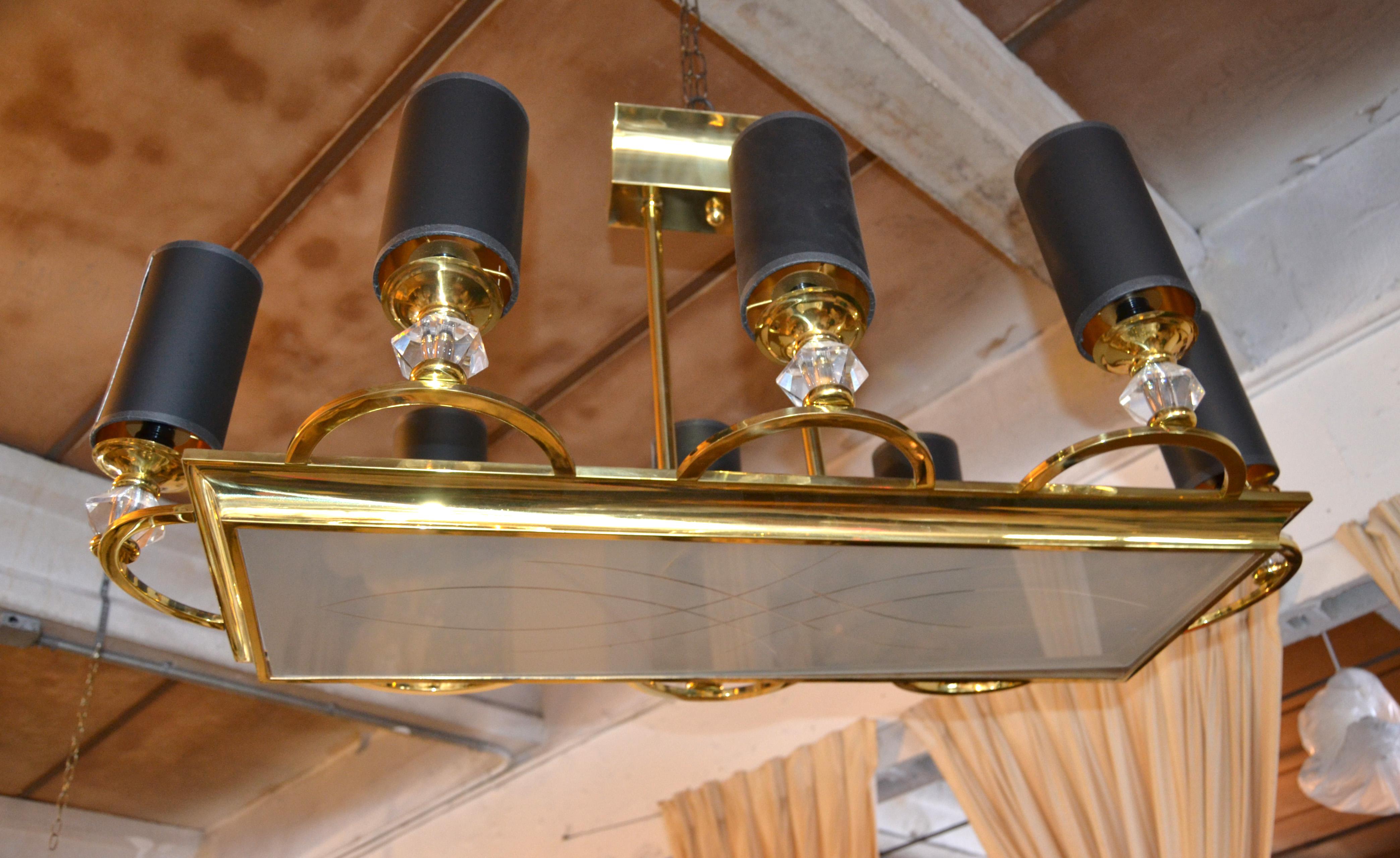 Monumental 8 Light Maison Jansen chandelier in Brass with custom made Black & Gold Cylinder Paper Shades.
Features a heavy Brass Frame with etched and frosted rectangle Glass.
Each Socket has Brass cups and a faceted Glass bobeche all handmade in