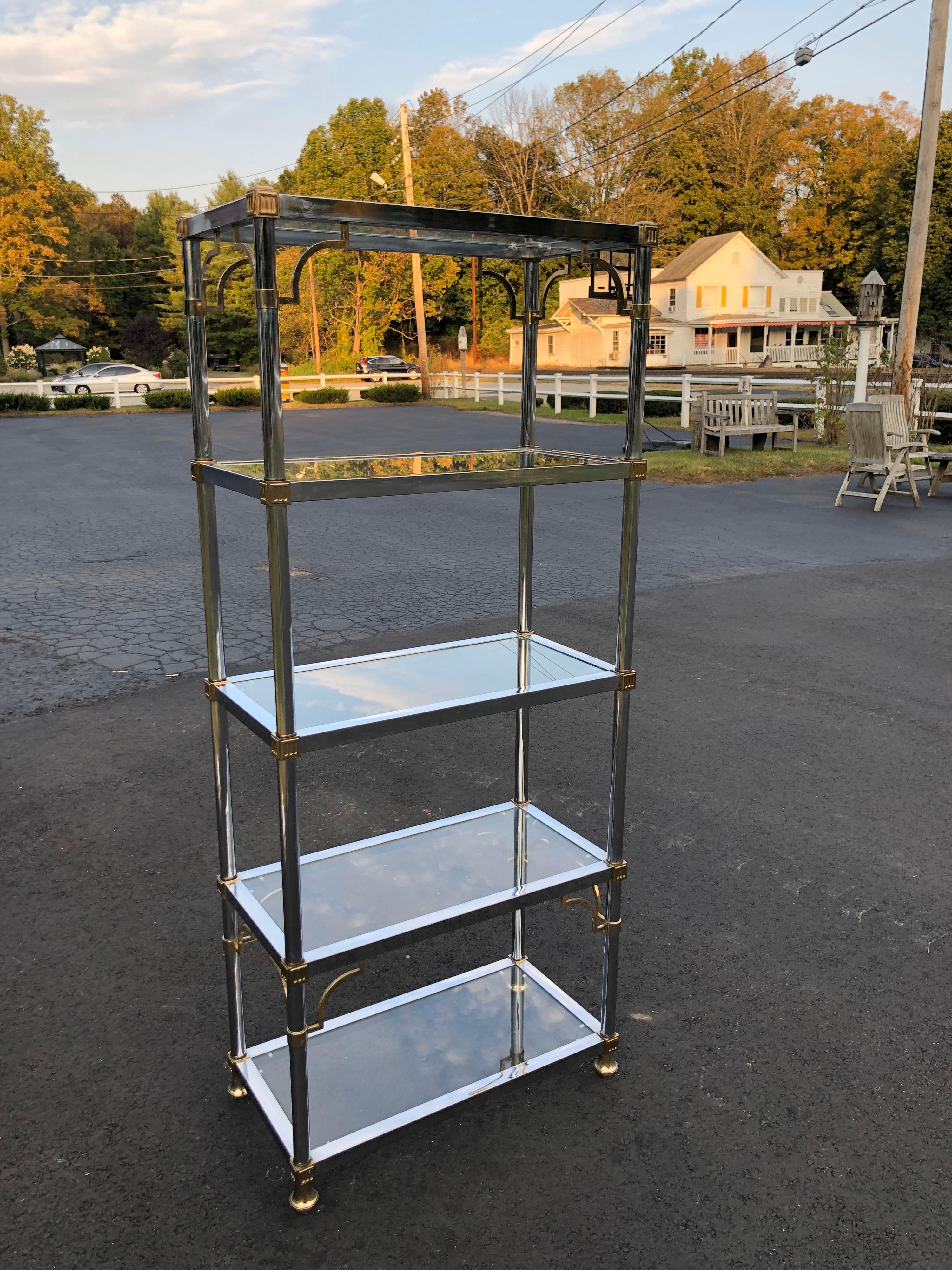 Maison Jansen Chrome and glass étagère with brass accents. Classic storage and display for any room in home or office. Has 5 glass shelves for displaying your collectibles or books. The space between each shelf is 15.25