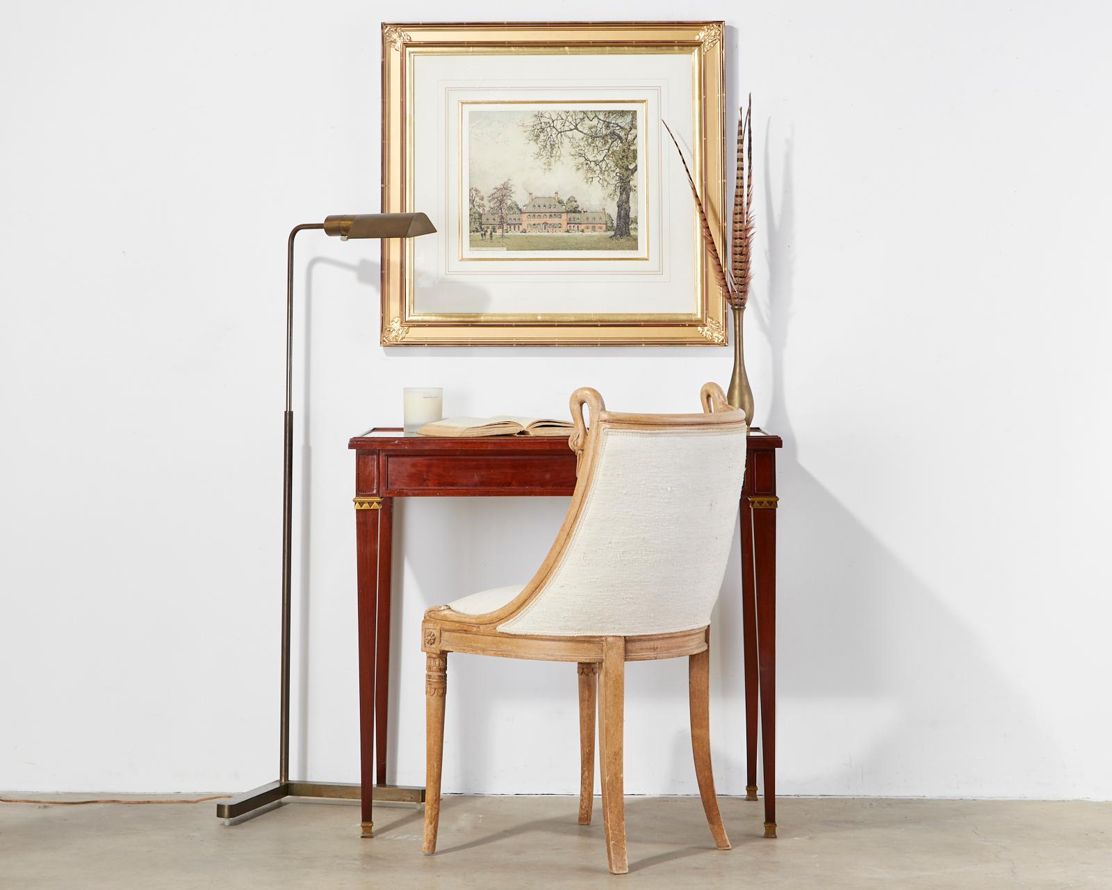 Elegant mahogany and bronze mounted writing table by Maison Jansen. Features a diminutive size leather topped case covered with a pane of glass. Crafted in the neoclassical directoire taste supported by bronze mounted tapered legs ending with