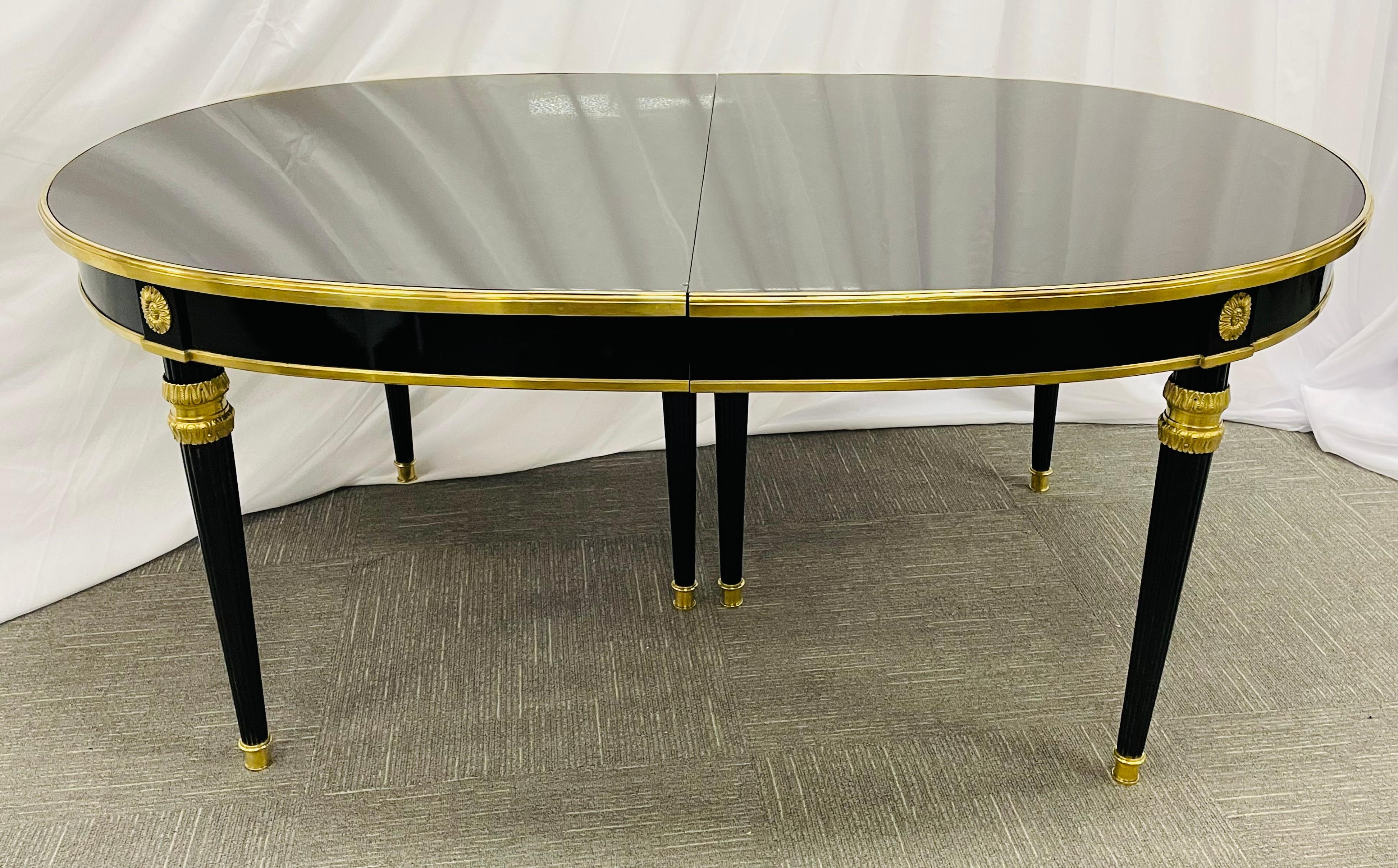 Dining table by Maison Jansen having two 18 inch leaves to extend to seat up to ten to twelve people. This Steinway Black Lacquered dining table has reeded tapering legs on bronze castes terminating in thick finely cast bronze terminals supporting a