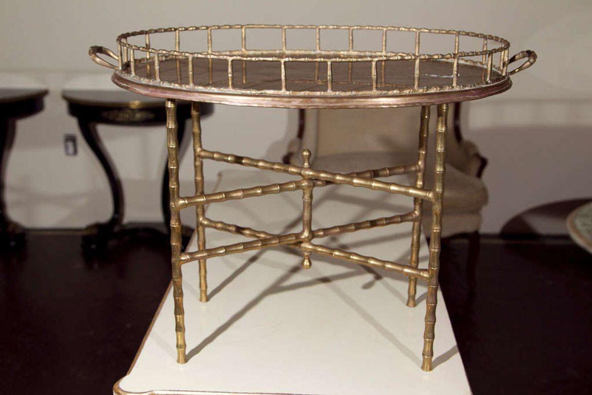 A chic bronze faux bamboo table, the tray top with handles raised on a folded base. Stamped Jansen Industria, Argentina.