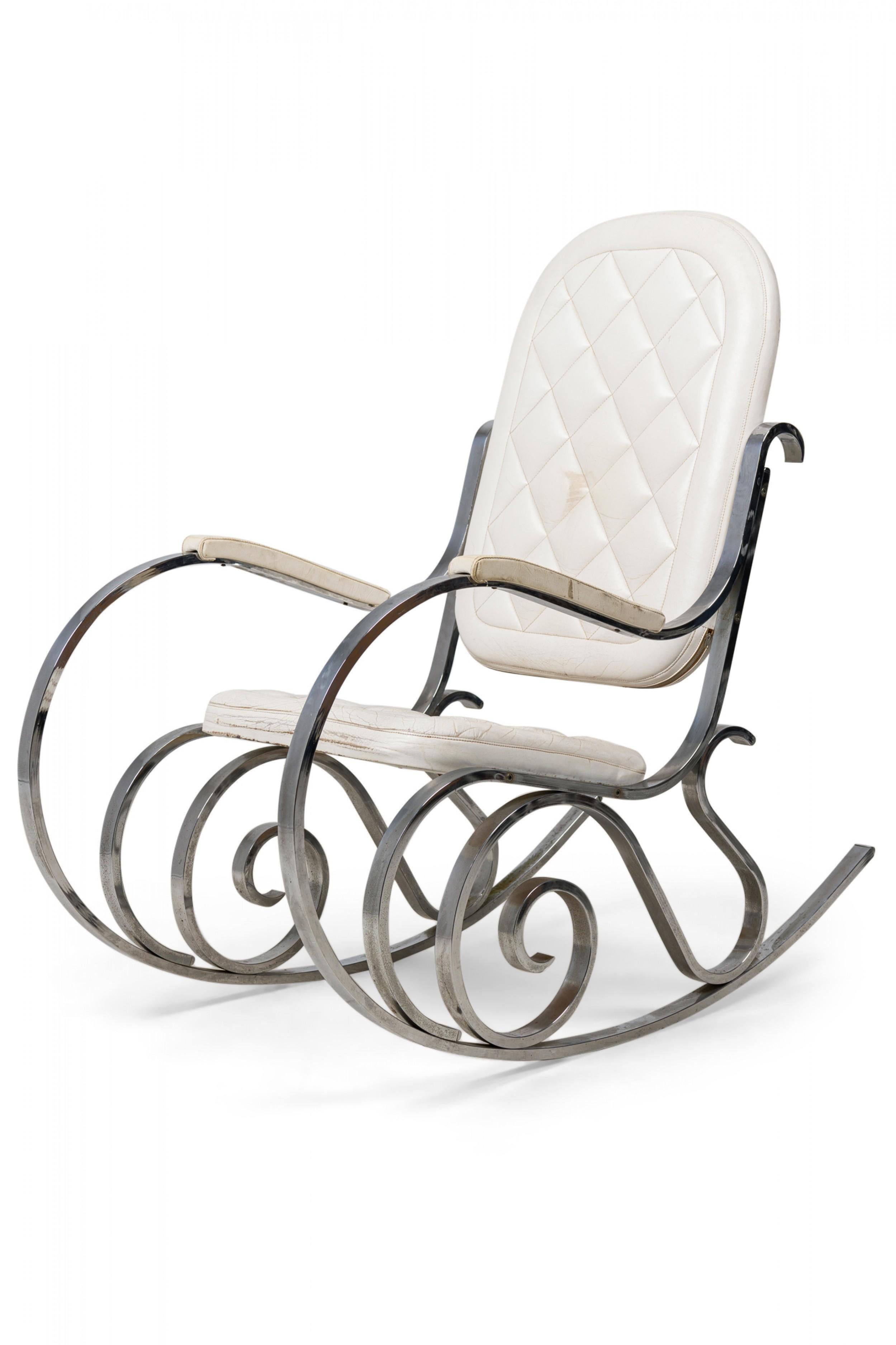 French midcentury rocking armchair with an ornate polished nickel scroll design frame with quilted white leather upholstered seat and back. (Maison Jansen)(Available in black leather: REG5217A).