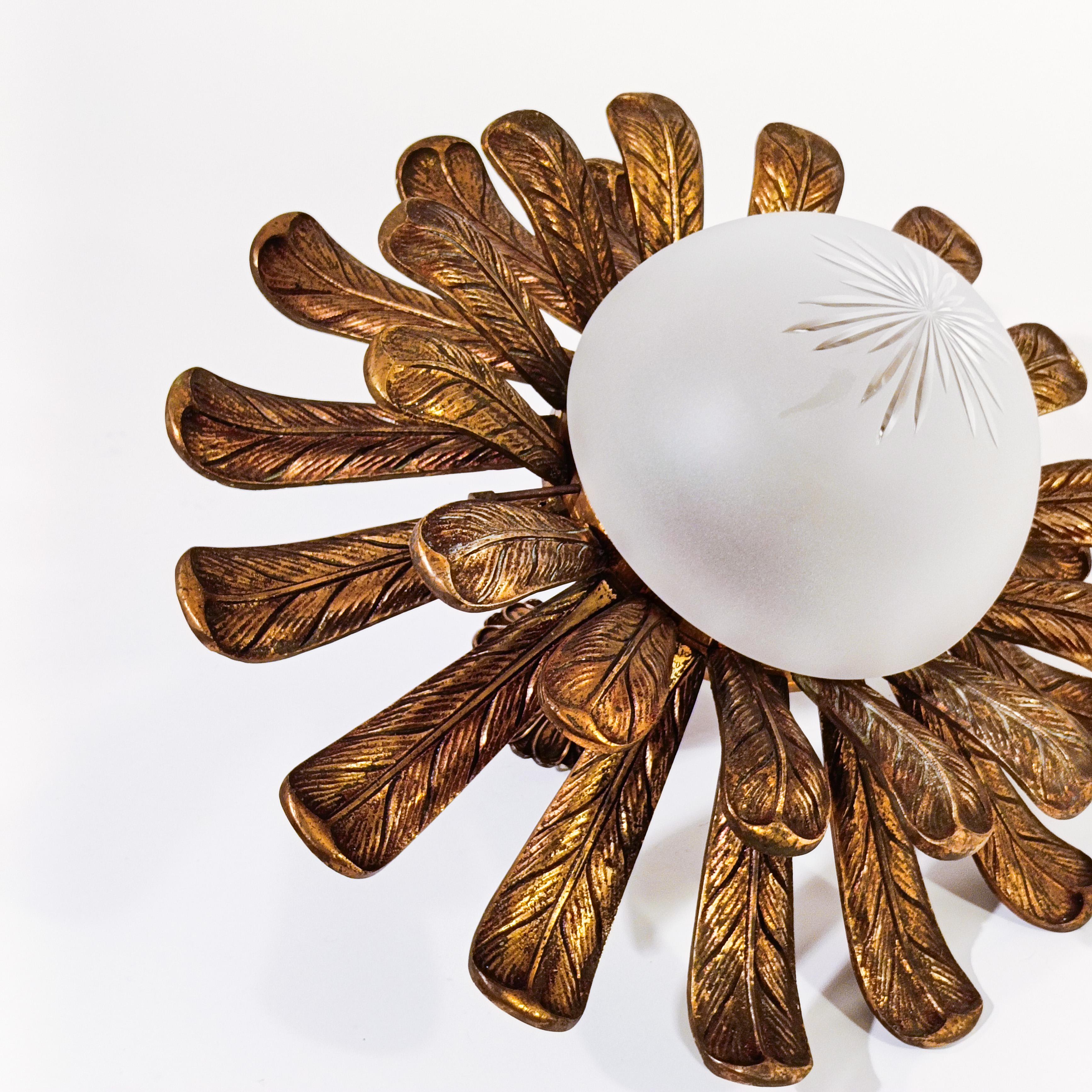 Bronze flush mount in the style of Maison Jansen creations, France, 1950s. Formed by a solid bronze metal structure where multiple leaves arranged on two levels are screwed to a central piece of the same metal. The leaves can be seen as bird
