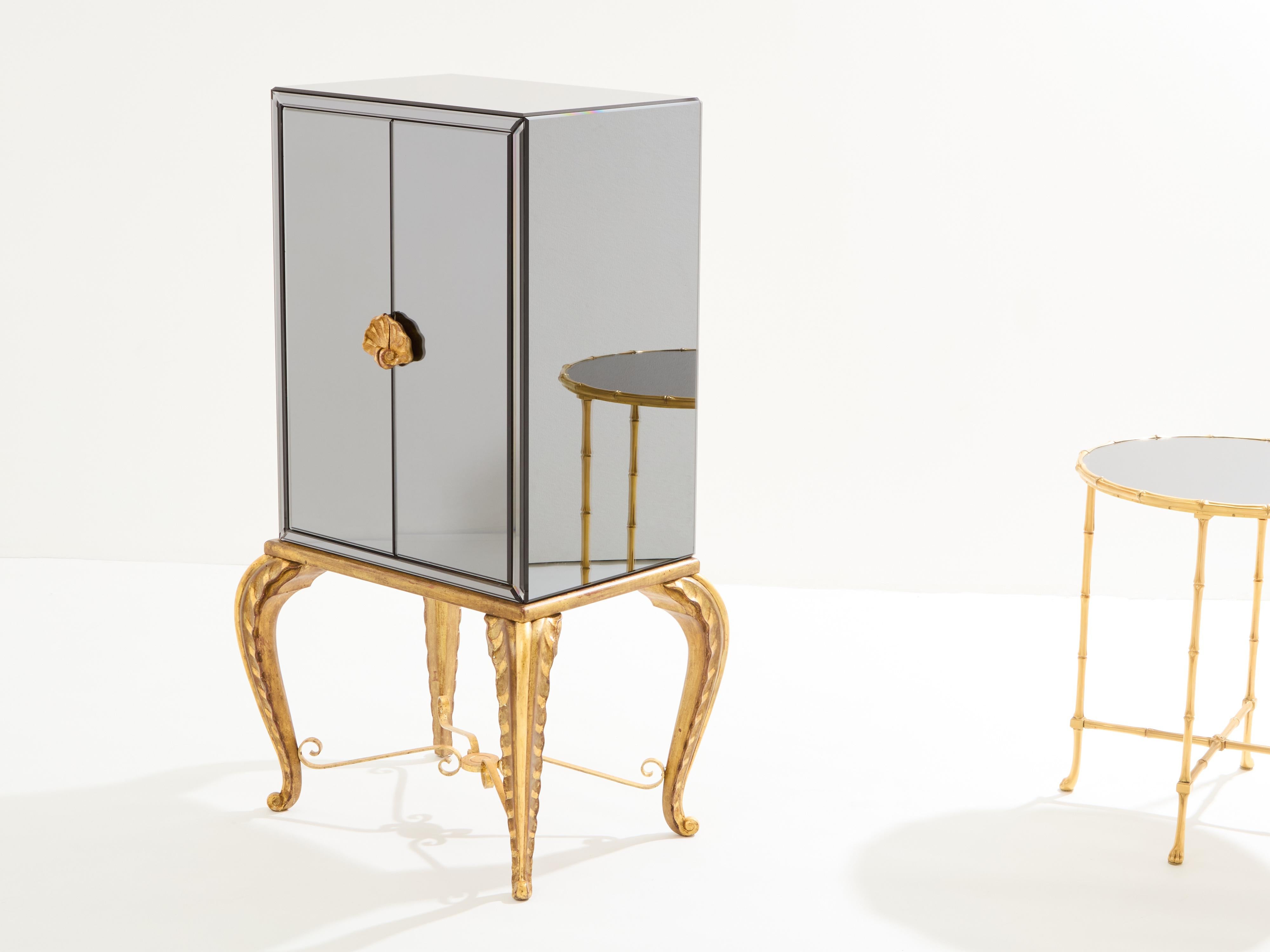 This cabinet bar by Maison Jansen was made in the 1940s, with beautifully carved wood feet, body frame and door handles, and with iron pieces between the legs, all fully gilt. It features a body in French oakwood fully covered with grey smoked