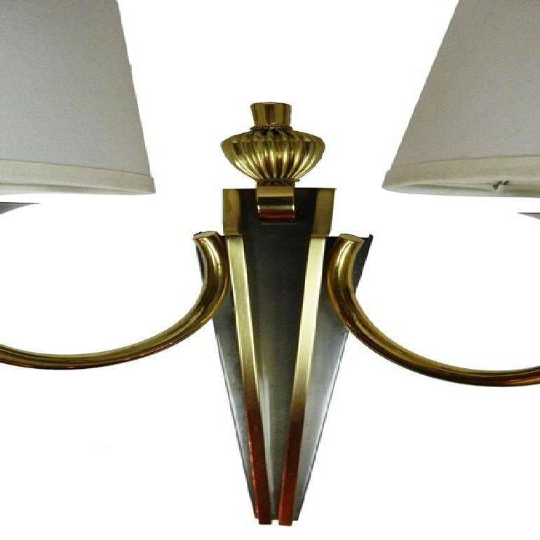Superb two-tone brass and gun metal pair of sconces by Maison Jansen. US rewired and in working condition. Two bulb of 75 watts max. Custom back plate available, ask for a quote. Two pairs available (Four sconces). Priced by pair. Have a look on our