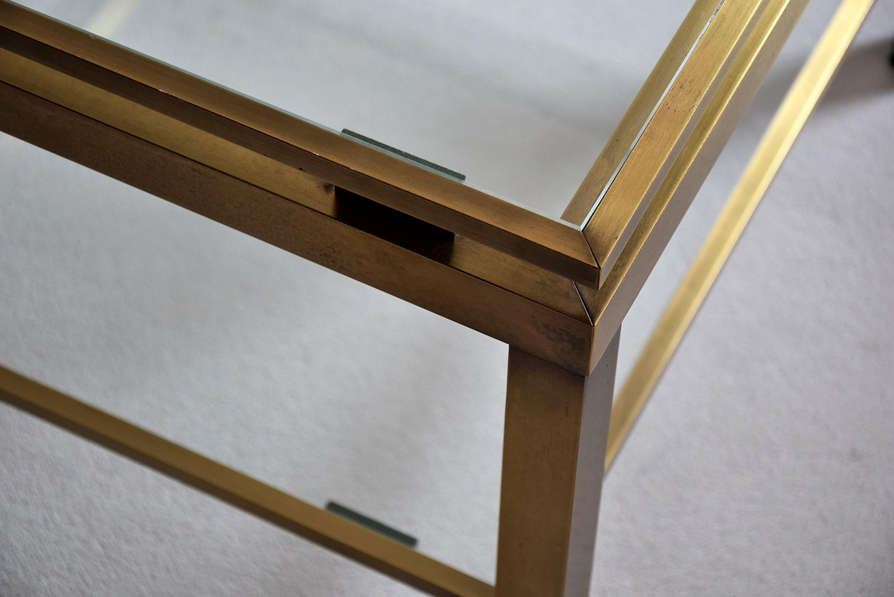 Brass side table by Maison Jansen. Stylish Mid-Century Modern two-tier coffee table by Maison Jansen.
This sophisticated piece is in excellent condition.

Measurements: D 60.5 x W 60.5 x H 46 cm.
The table will be shipped overseas in a custom made