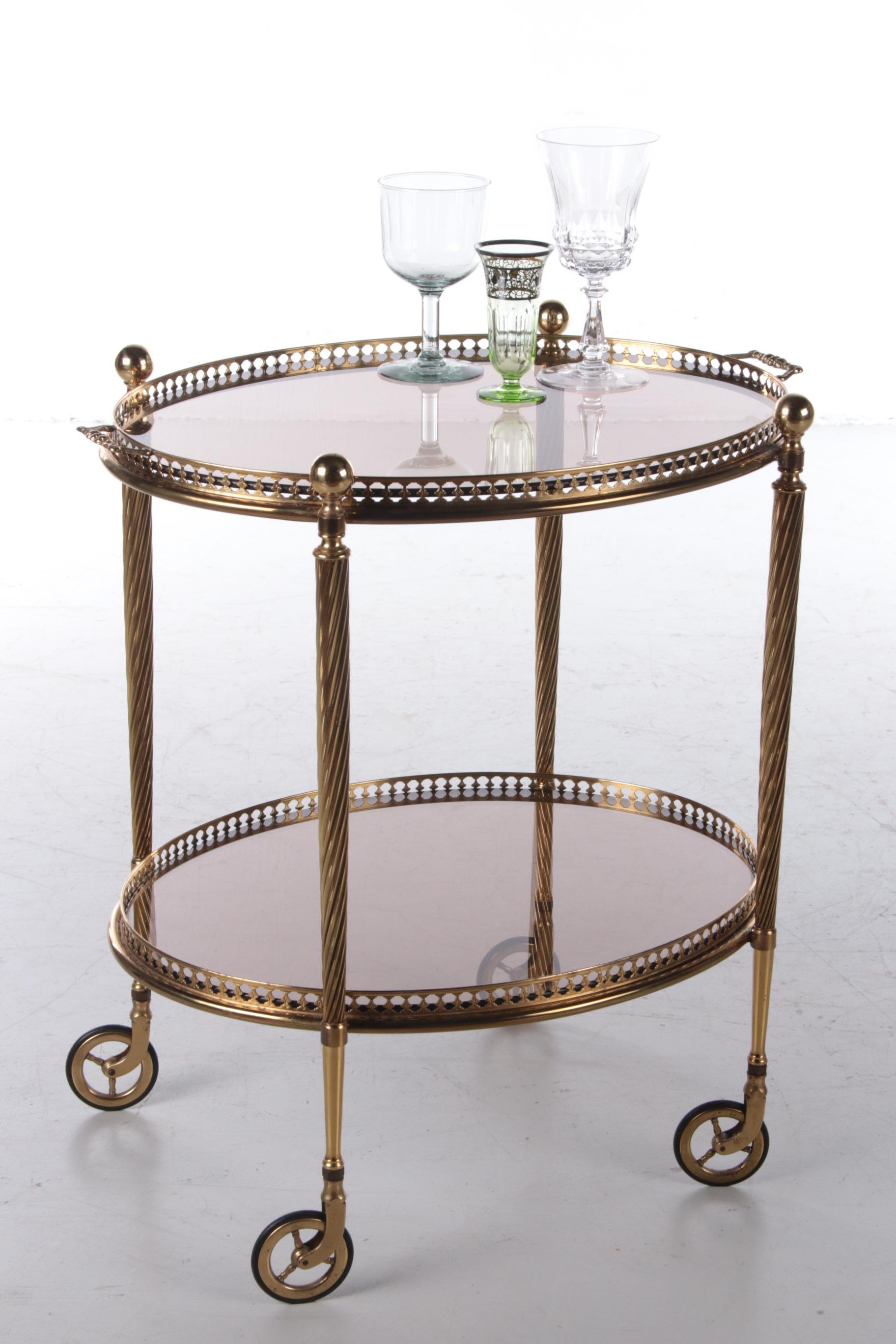 Maison Jansen Hollywood Regency trolley, 1950s


A beautiful Maison Jansen brass vintage trolley with two layers. Nicely round in shape with a brass frame and glass plates. The top tray is removable and can also be used as a tray.

Maison