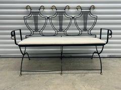 Iron lyre back settee with brass swans heads and paw  feet