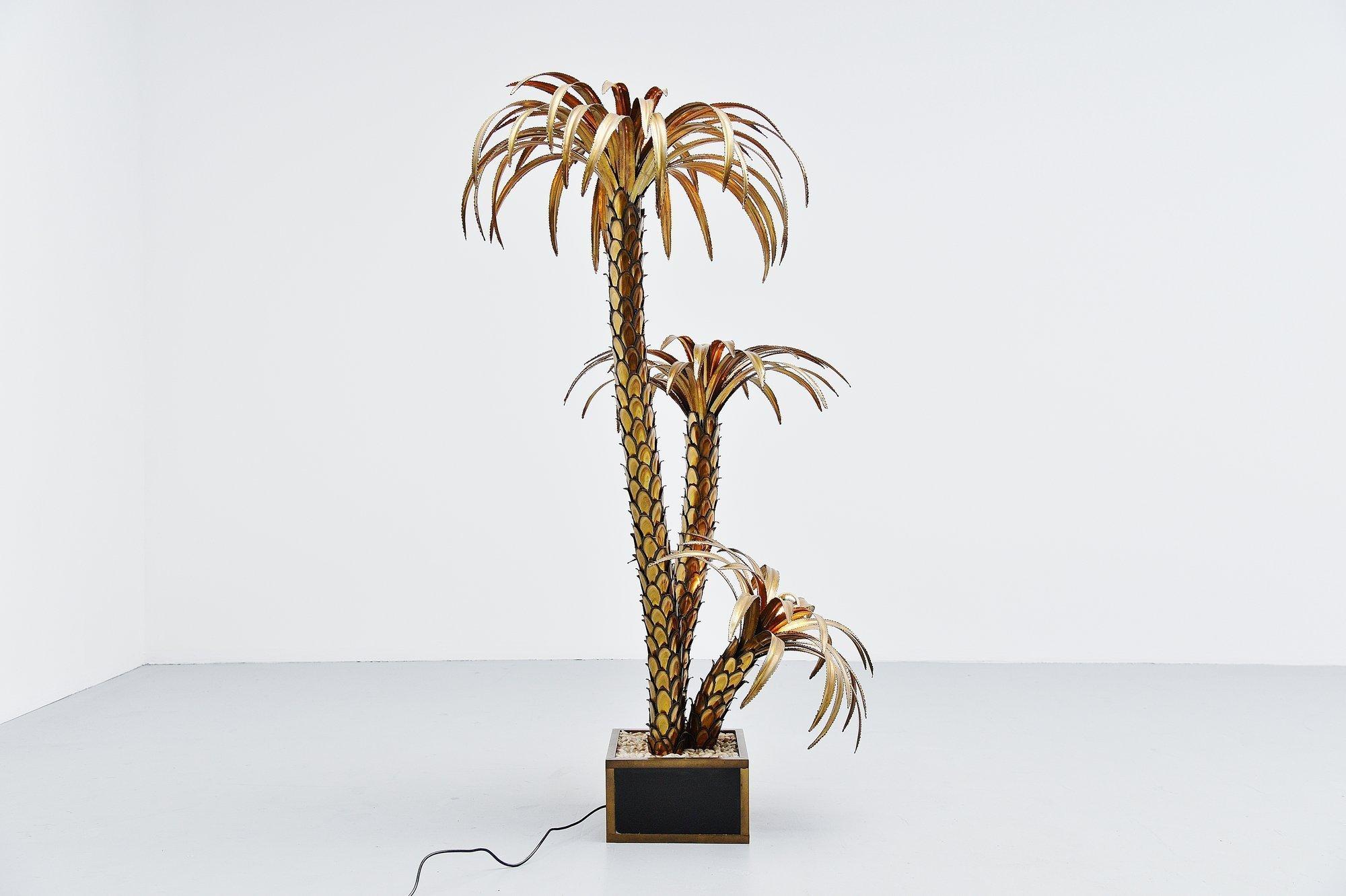 Stunning large floor lamp palm tree shaped, made and designed by Maison Jansen, France 1970. This spectacular large palm tree floor lamp has a dark brown patinated brass base with brass edges and real stones glued inside. The leafs are made of brass