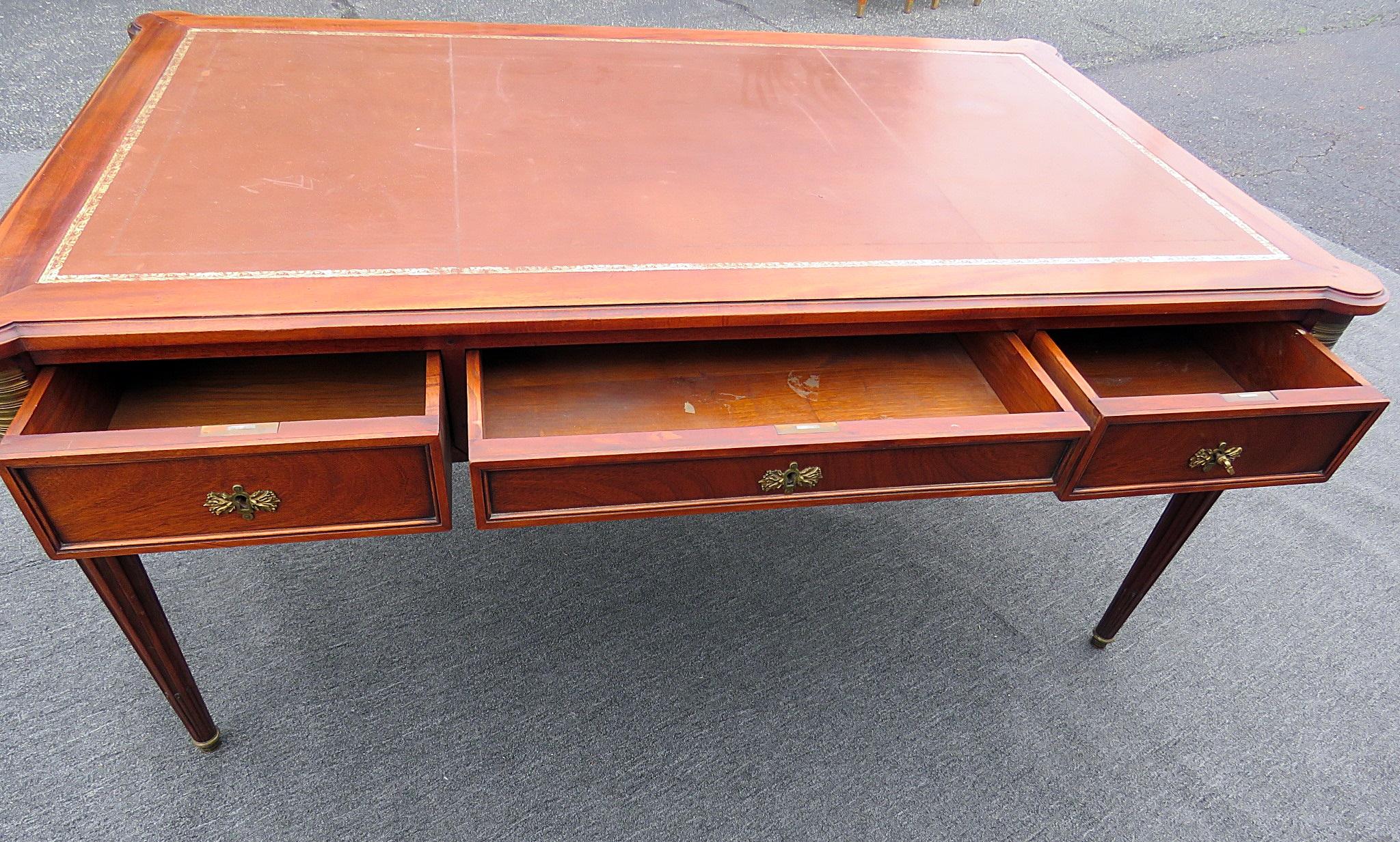 Maison Jansen Louis XVI style leather top desk with three drawers and two slide out extensions. Extends to 94